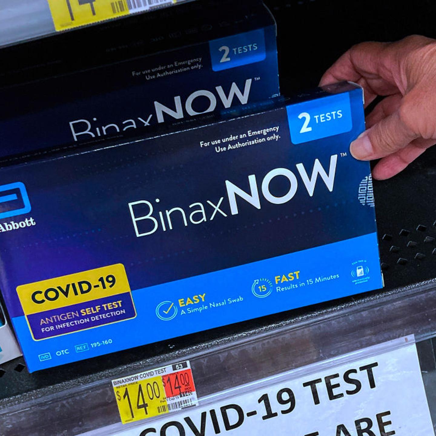 At-home COVID-19 test kits on a shelf at a Walmart in Orlando, Fla.