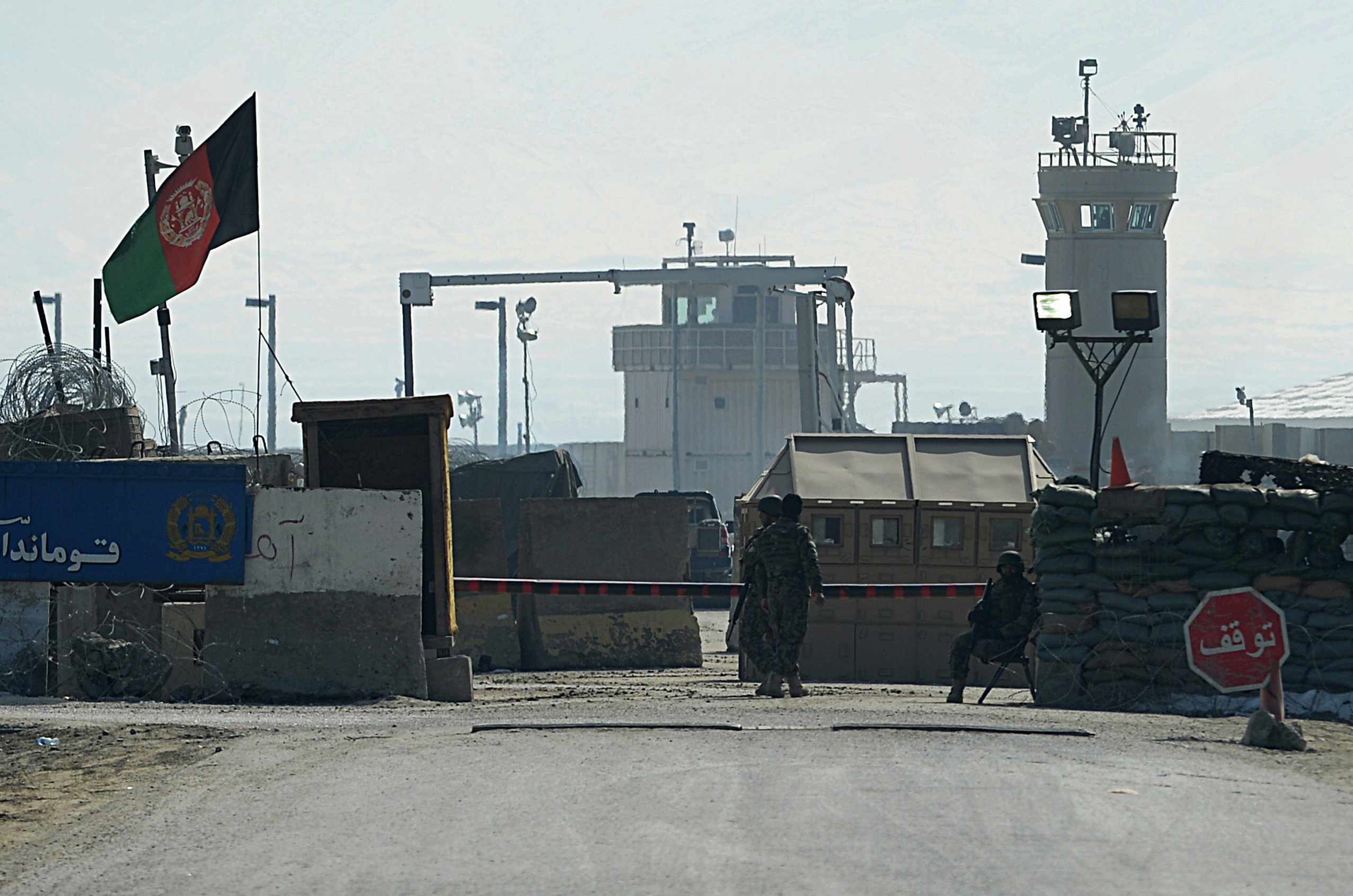 Afghan National Army soldiers stand guard at the Bagram prison gate, Feb. 13, 2014.