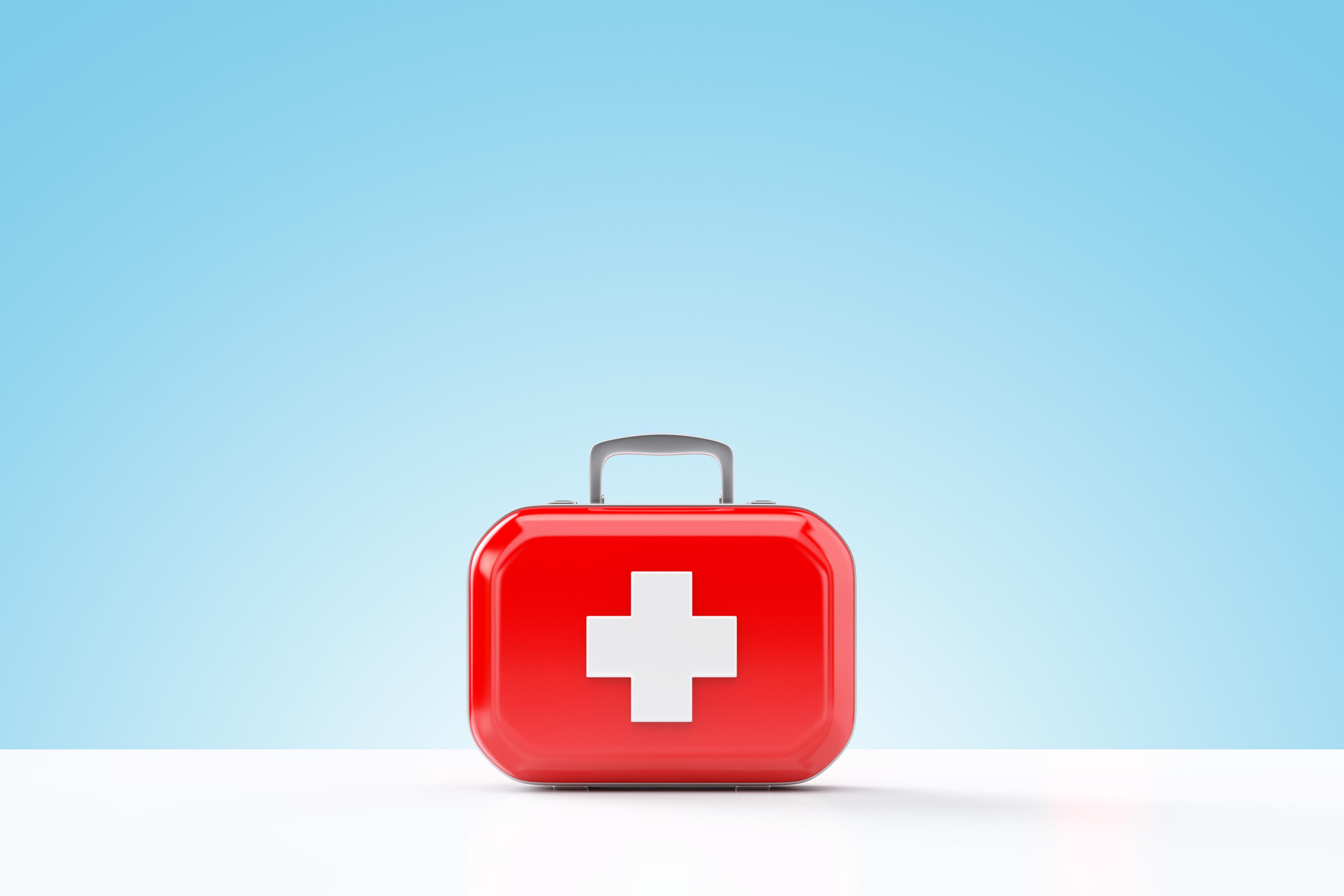 First aid kit standing on a blue and white background TIME health stock