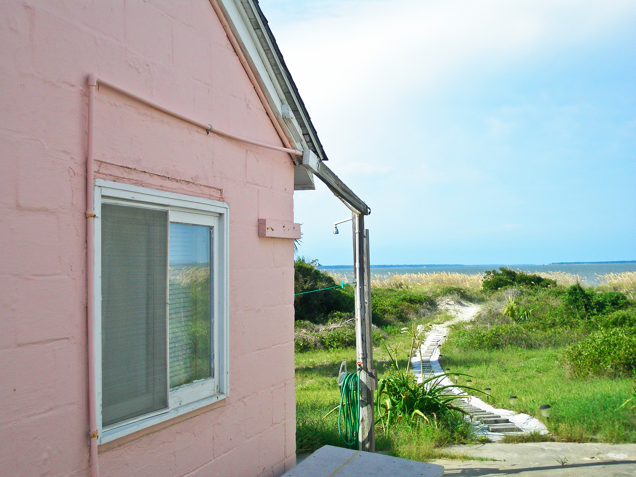 Side facade of cottage on Pulaski Street, Tybee Island, Georgia. Homes on this street were formerly barracks for enlisted men when Fort Screven was an active military installation.
