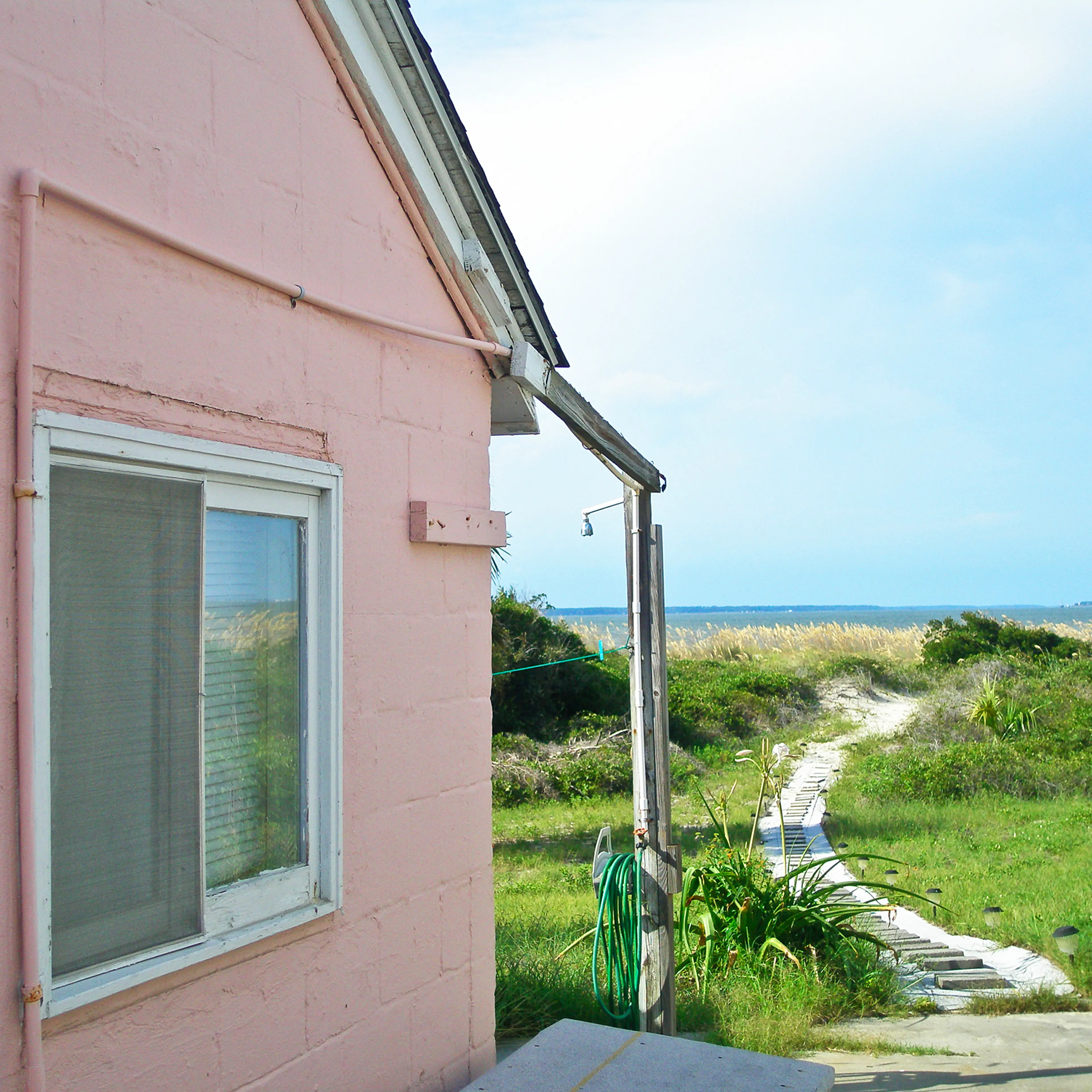 Side facade of cottage on Pulaski Street, Tybee Island, Georgia. Homes on this street were formerly barracks for enlisted men when Fort Screven was an active military installation.