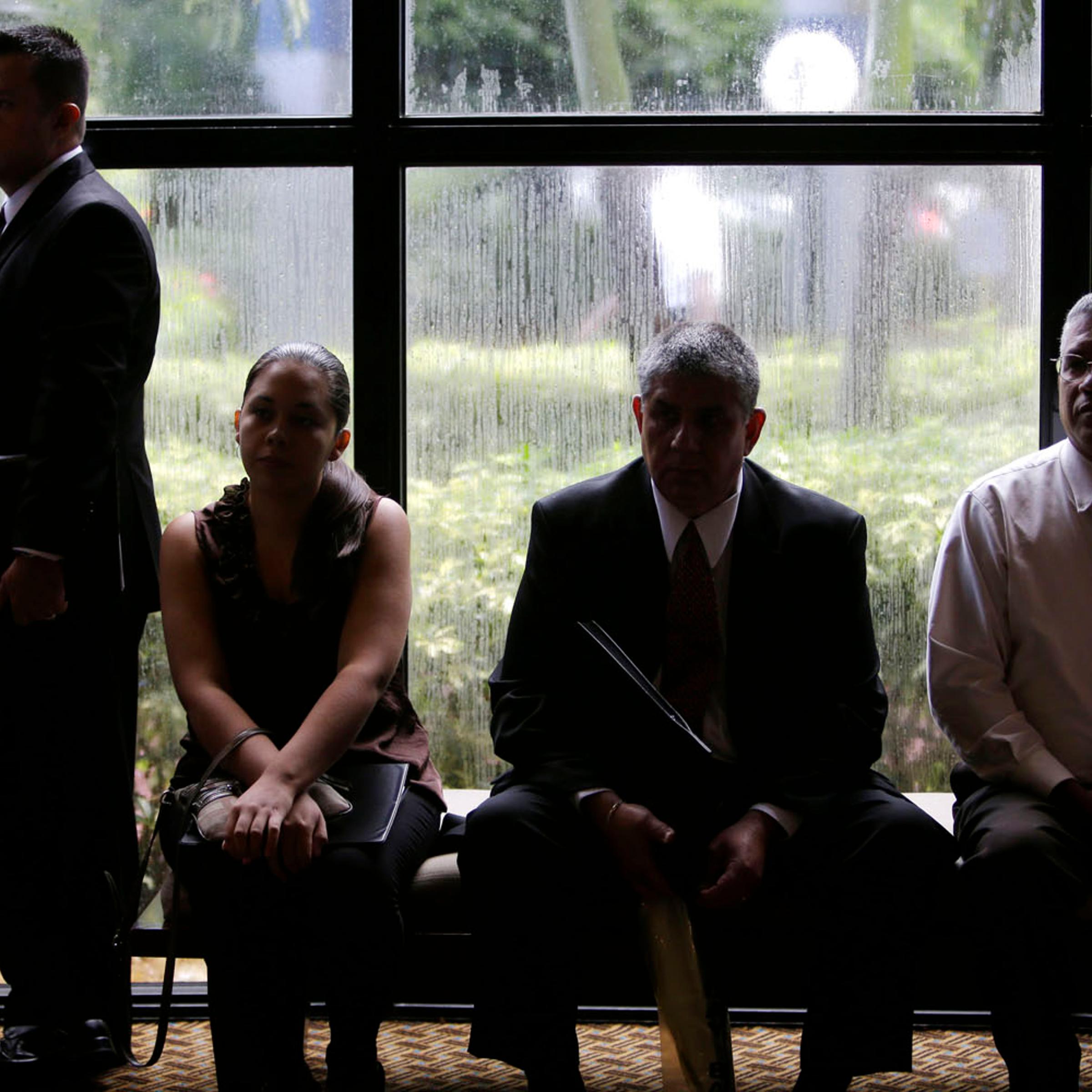 Job applicants wait for the opening of a job fair held by National Career Fairs in Fort Lauderdale, Fla., Sept. 17, 2012.