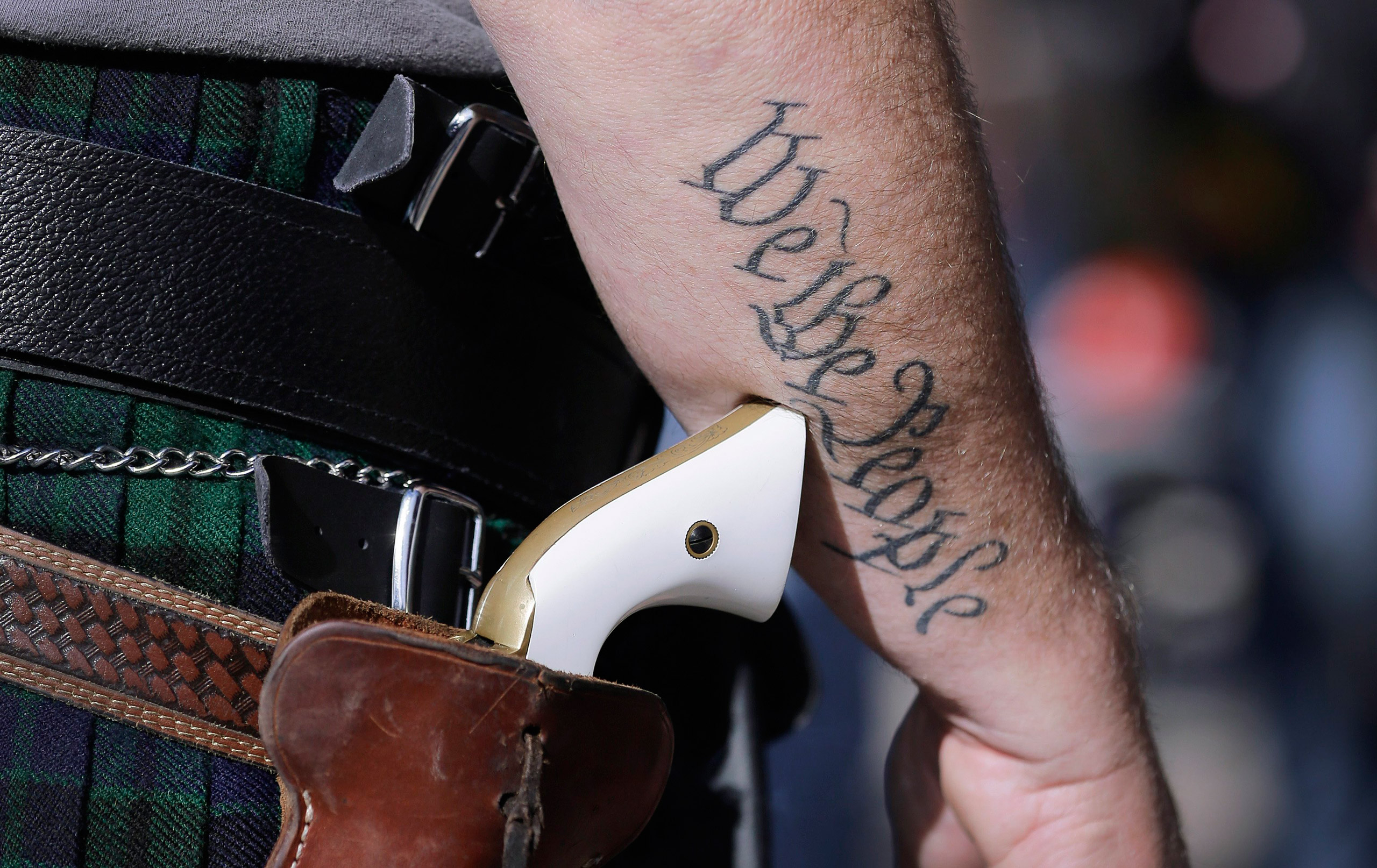 FILE - In this Jan. 26, 2015 file photo, Scott Smith, a supporter of open carry gun laws, wears a pistol as he prepares for a rally in support of open carry gun laws at the Capitol, in Austin, Texas. Texas the second-most populous state, is joining 44 ot