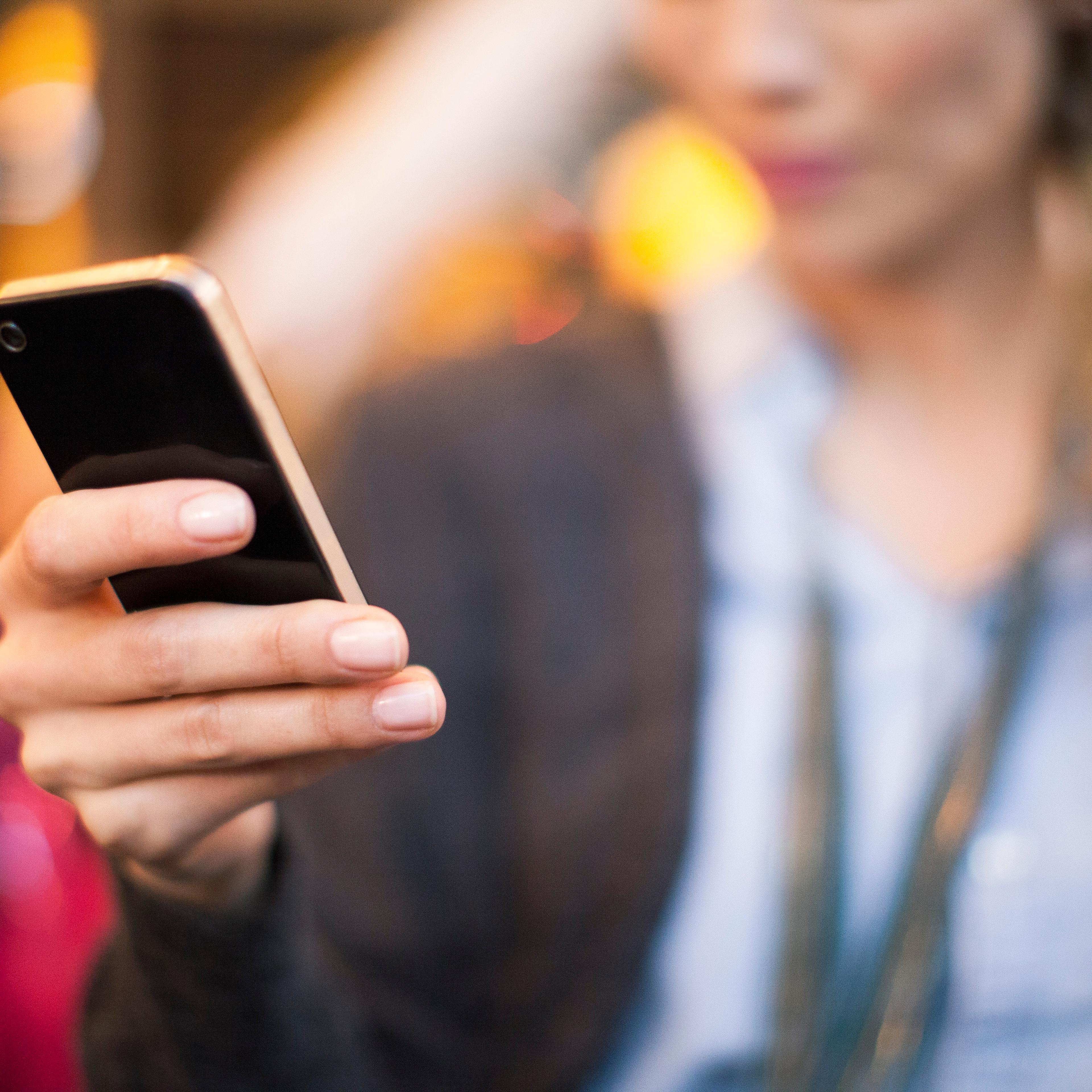 Woman taking selfie with smartphone