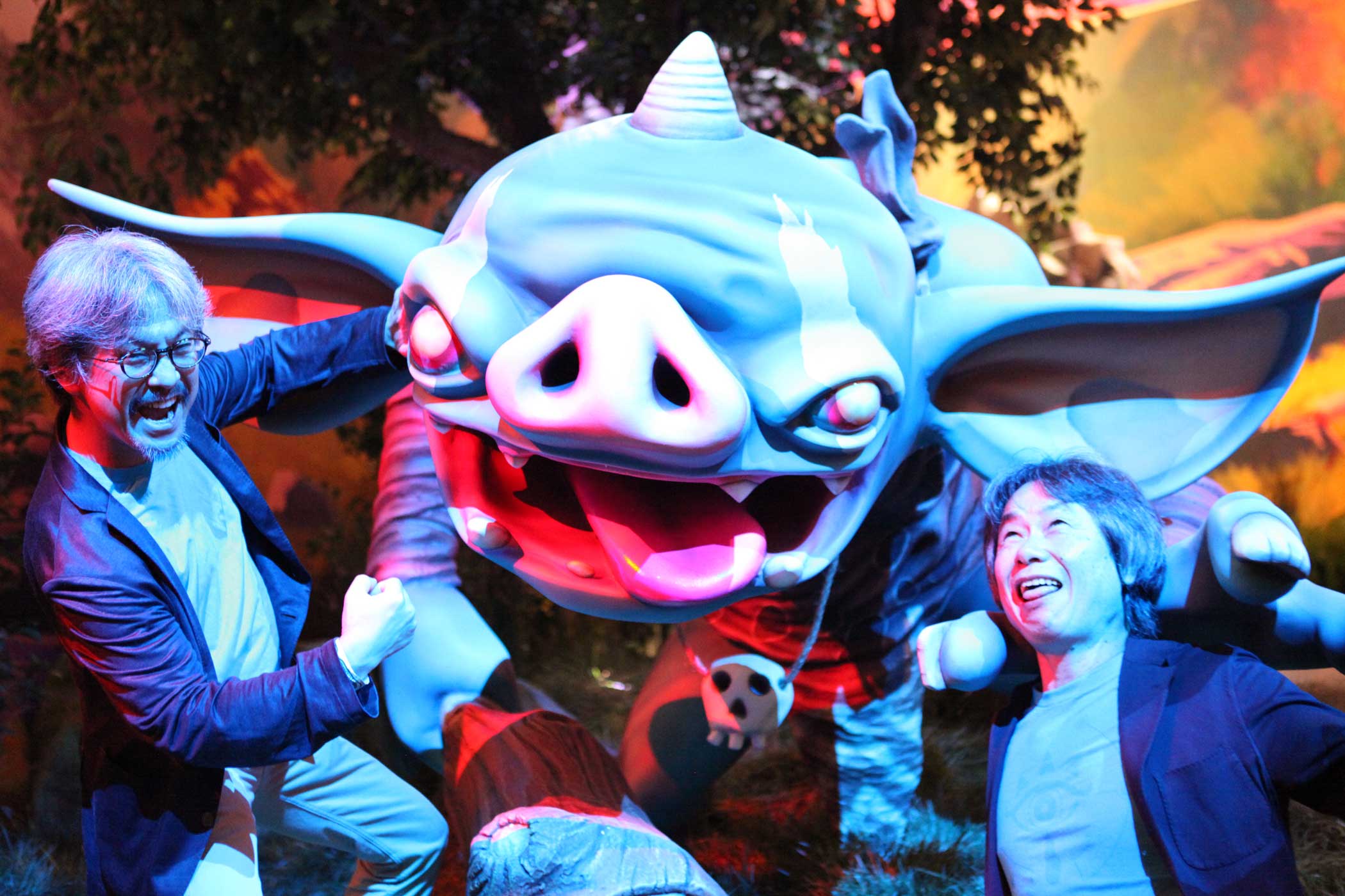 Eiji Aonuma (left) and Shigeru Miyamoto (right) pose in front of a Goblin in the E3 2016 Nintendo booth