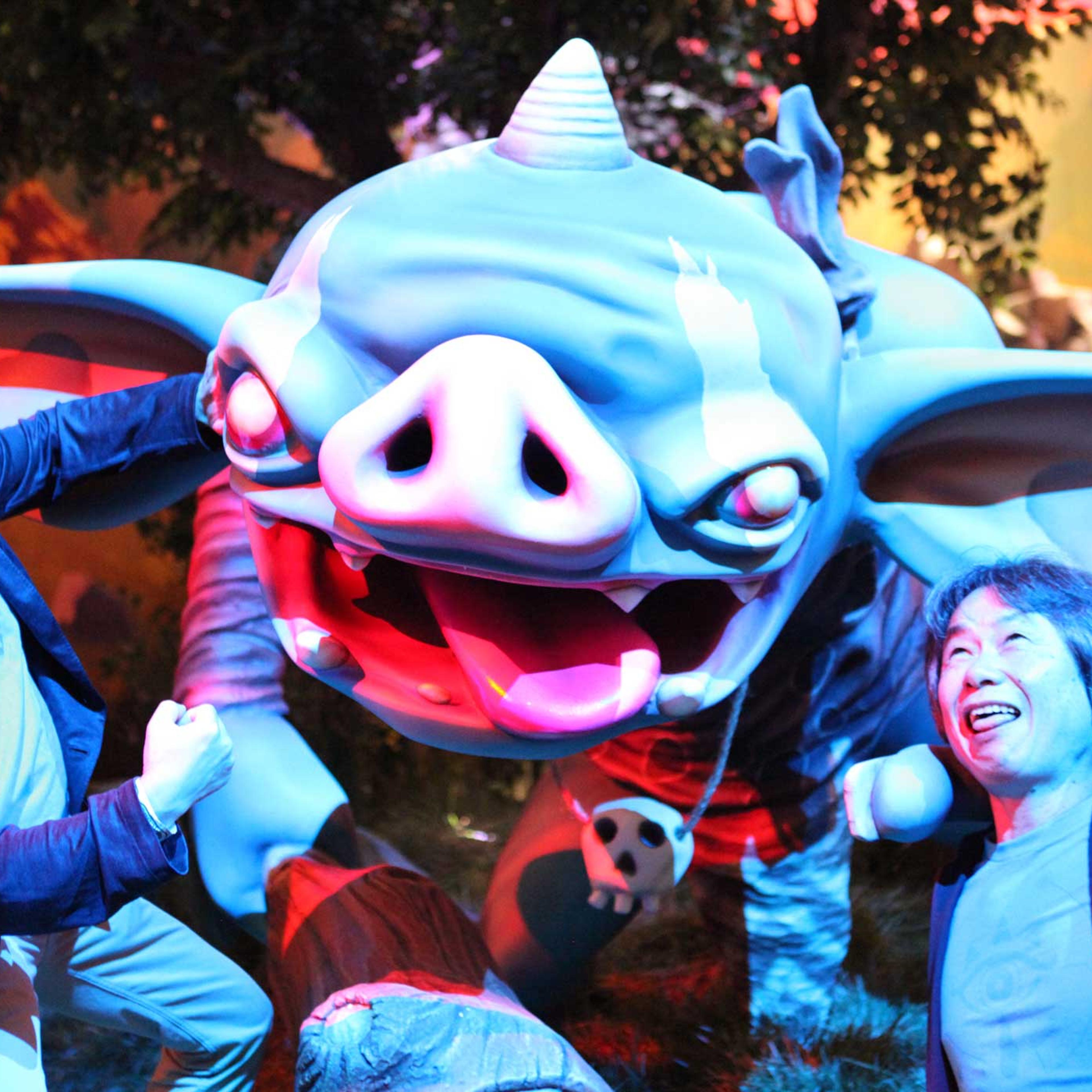 Eiji Aonuma (left) and Shigeru Miyamoto (right) pose in front of a Goblin in the E3 2016 Nintendo booth