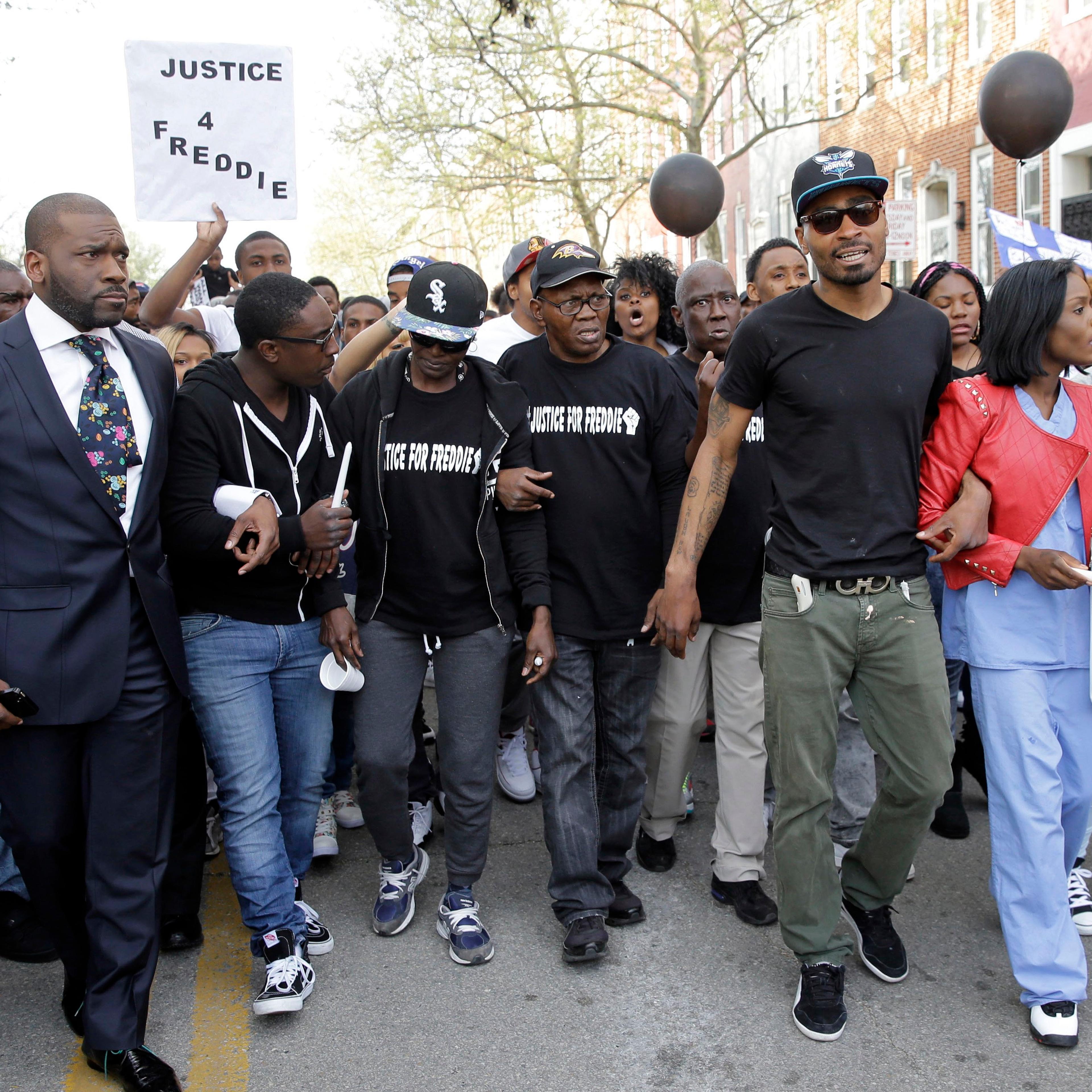 Gloria Darden, third from left, mother of Freddie Gray, walks with supporters and family members of Gray in a march to the Baltimore Police Department's Western District police station during a vigil for Gray on April 21, 2015, in Baltimore.