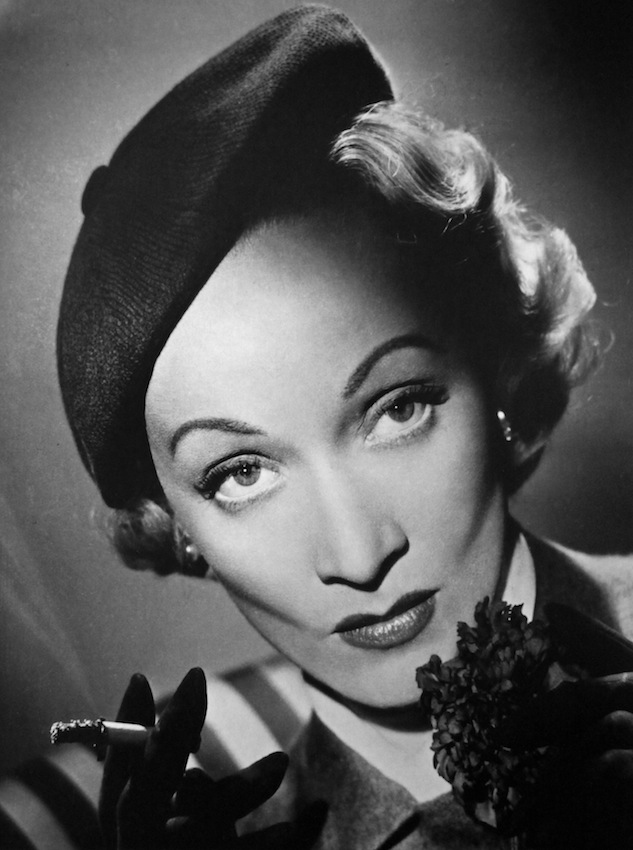 <b>Marlene Dietrich, 1948</b></br></br><i>"I first had the opportunity to photograph Marlene Dietrich whilst working at Denham Studios. I rushed into the studio and was given a set on a small corner of an enormous 120 ft. by 80 ft. stage. I was nervous. Once set up, I waited in the dark, with my radio at the ready thinking it might help ease the situation and, more importantly, calm my nerves. Suddenly a light came on in the entrance to the studio a hundred feet away, and she and her entourage proceeded across the stage. <br /><br /> I only took five photographs of her that day. The shoot finished and she announced she would be back the next day to see the rough prints. I re-touched the prints following her explicit and detailed instructions to a tee. The next day Dietrich arrived, took out her magnifying glass again and re-examined the prints. Pleased, she turned to me, shook my hand and said, 'Join the club Mr. Lucas.' I was rather perplexed and wasn't sure what she meant so asked h