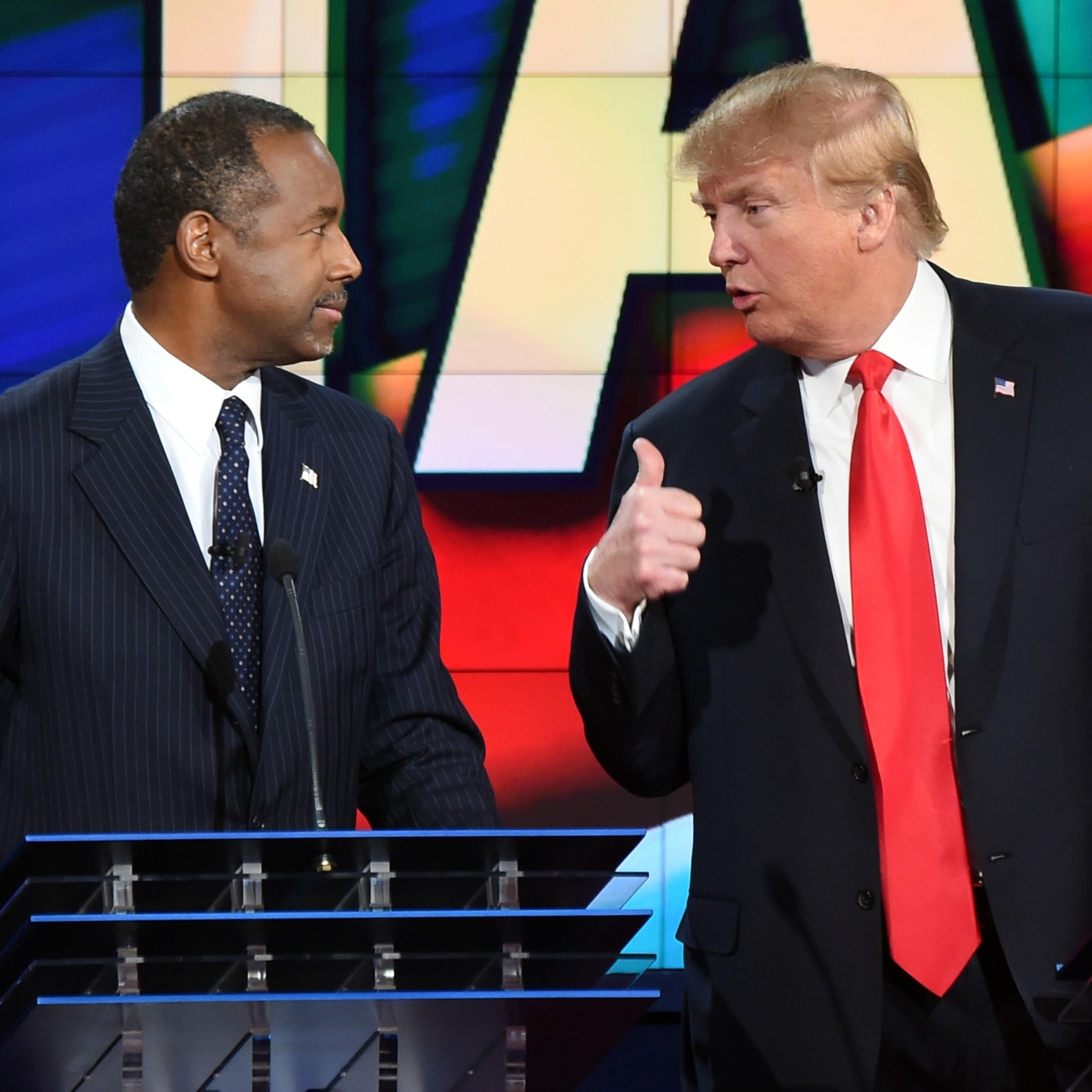 Republican presidential candidates Ben Carson, left and Donald Trump speak at a Republican presidential debate in Las Vegas in December.