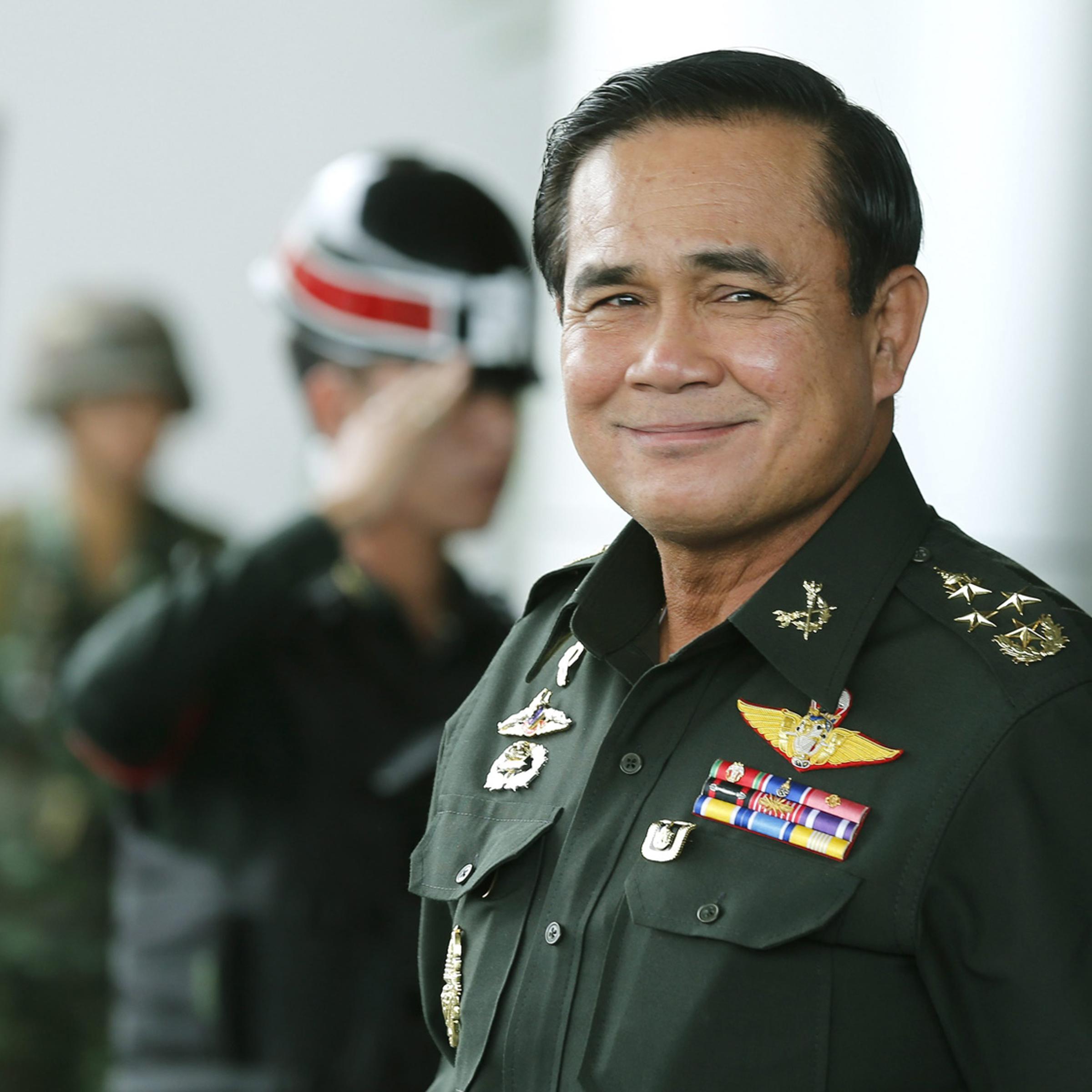 Thai army chief and junta head General Prayuth Chan-ocha smiles as he leave after the meeting of the 2015 national budget at the Army Club in Bangkok, June 13, 2014.