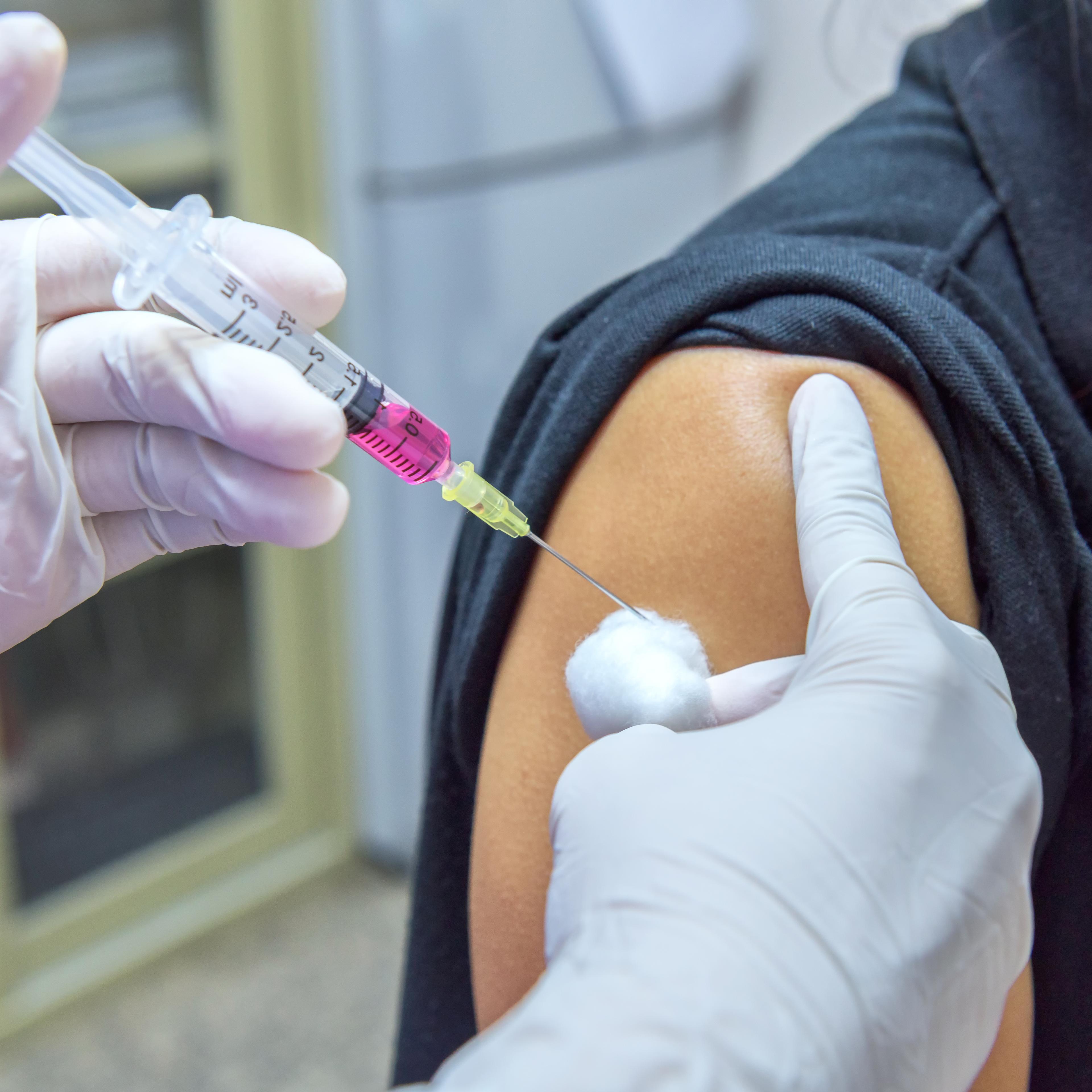 Close-up hands,nurses are vaccinations to patients using the syringe.Doctor vaccinating women in hospital.Are treated by the use of sterile injectable upper arm. injection