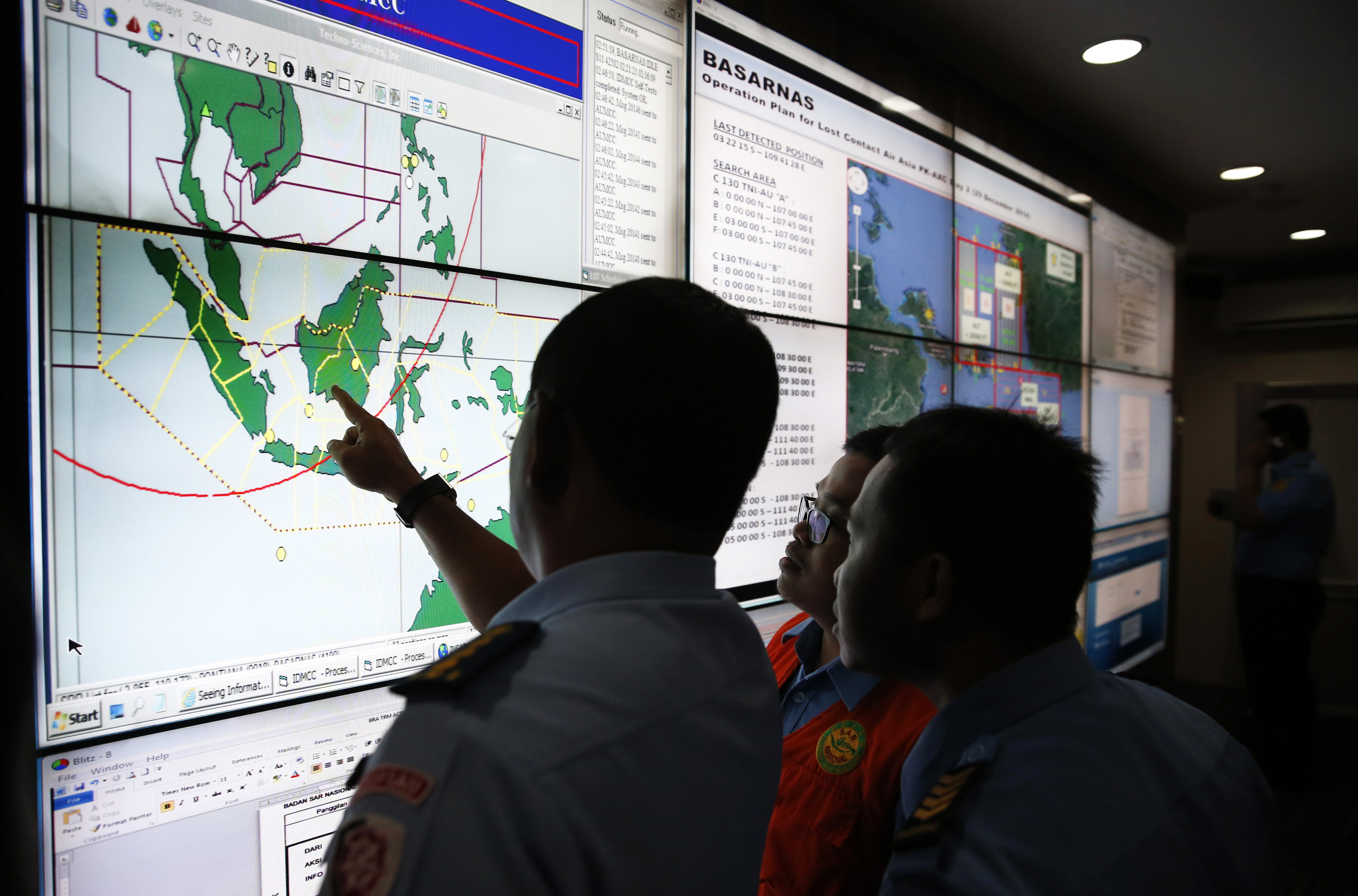Military and rescue authorities monitor progress in search for AirAsia Flight QZ8501 in Mission Control Center inside National Search and Rescue Agency in Jakarta