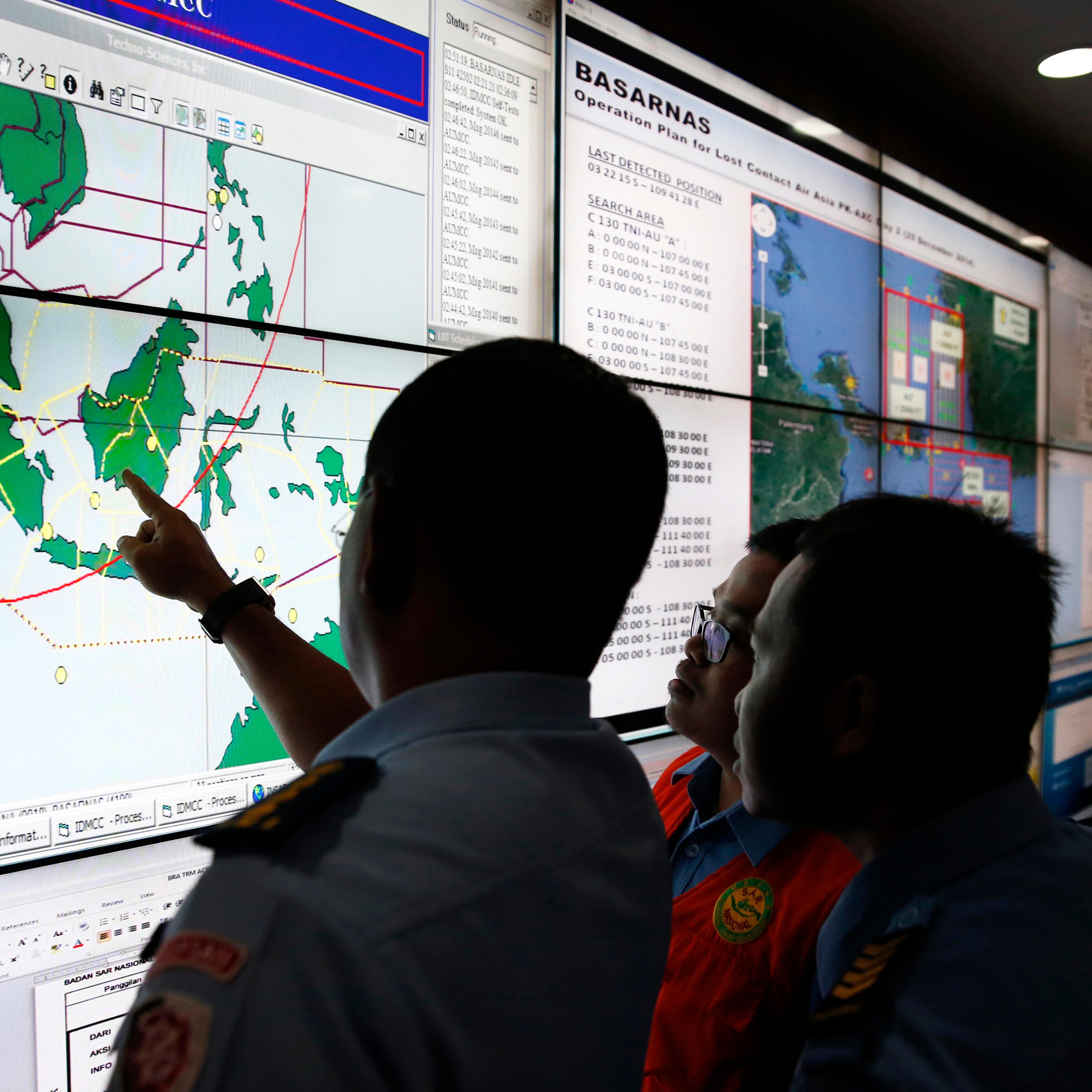 Military and rescue authorities monitor progress in search for AirAsia Flight QZ8501 in Mission Control Center inside National Search and Rescue Agency in Jakarta