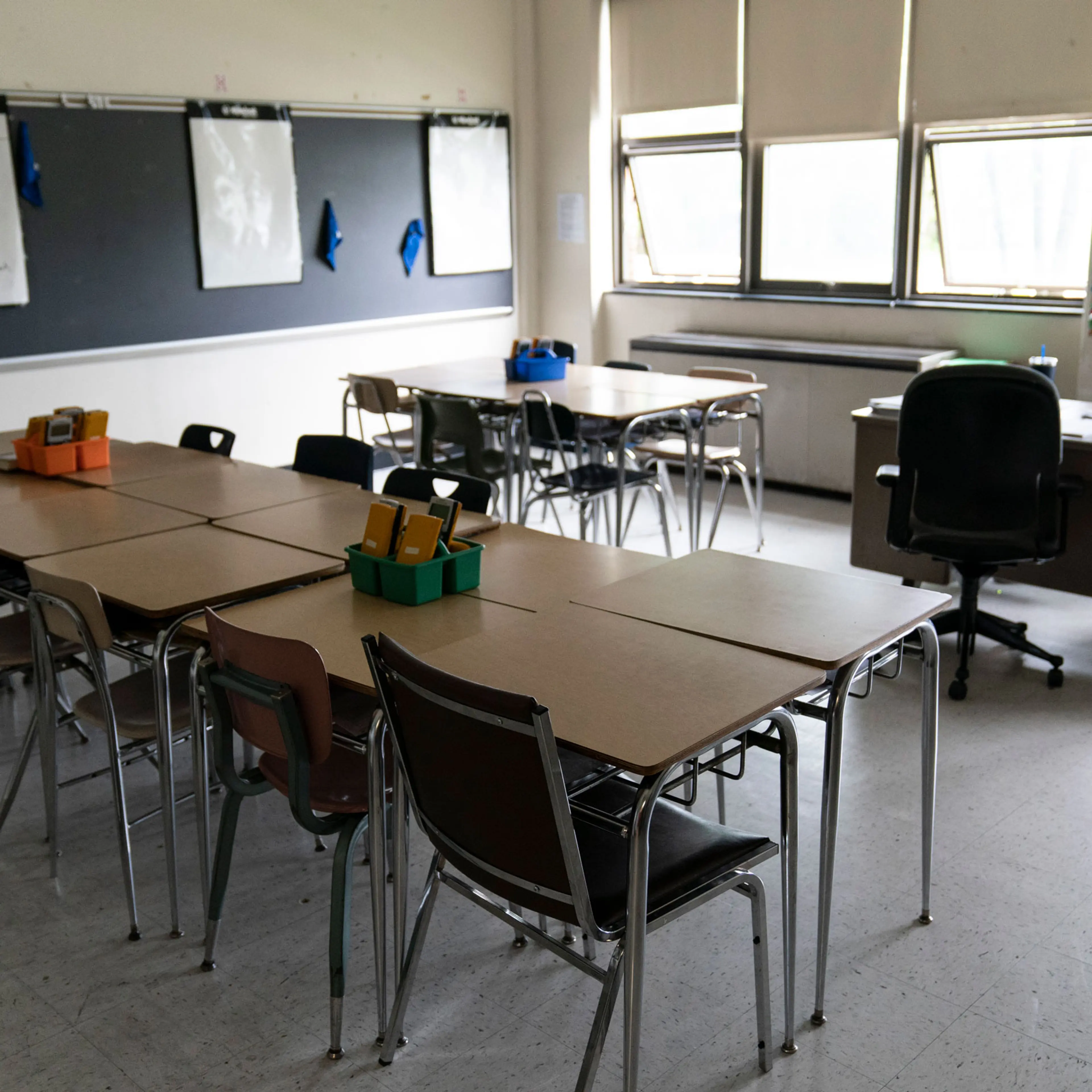 Desks fill a classroom in a high school