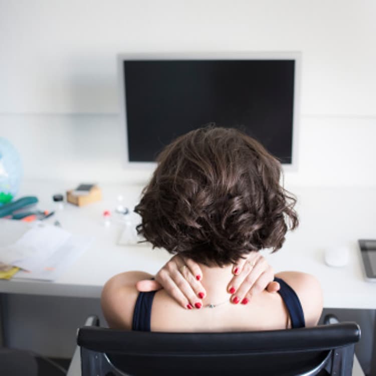 woman-massaging-neck-desk