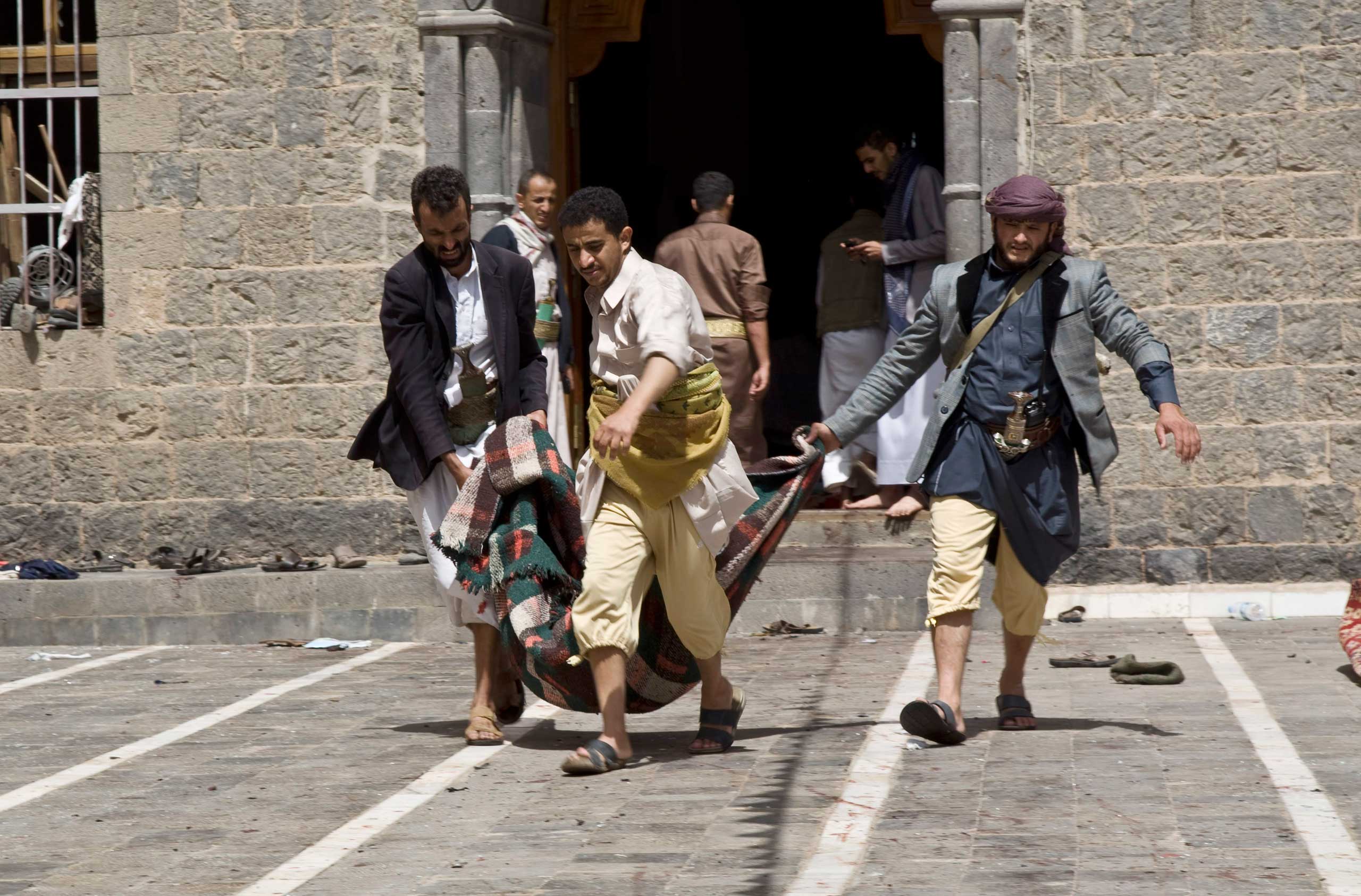 Yemenis carry a body of a man killed in a bomb attack in a mosque in Sanaa, Yemen, March 20, 2015.