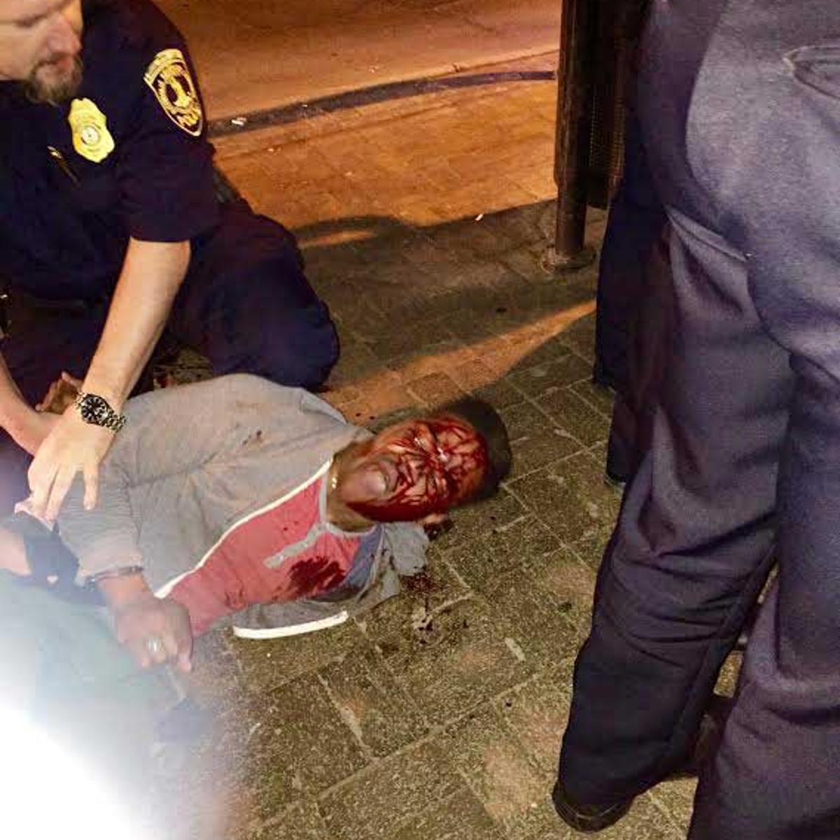 In this photo provided by Bryan Beaubrun, Martese Johnson is held down by an officer Wednesday, March 18, 2015, in Charlottesville, Va.