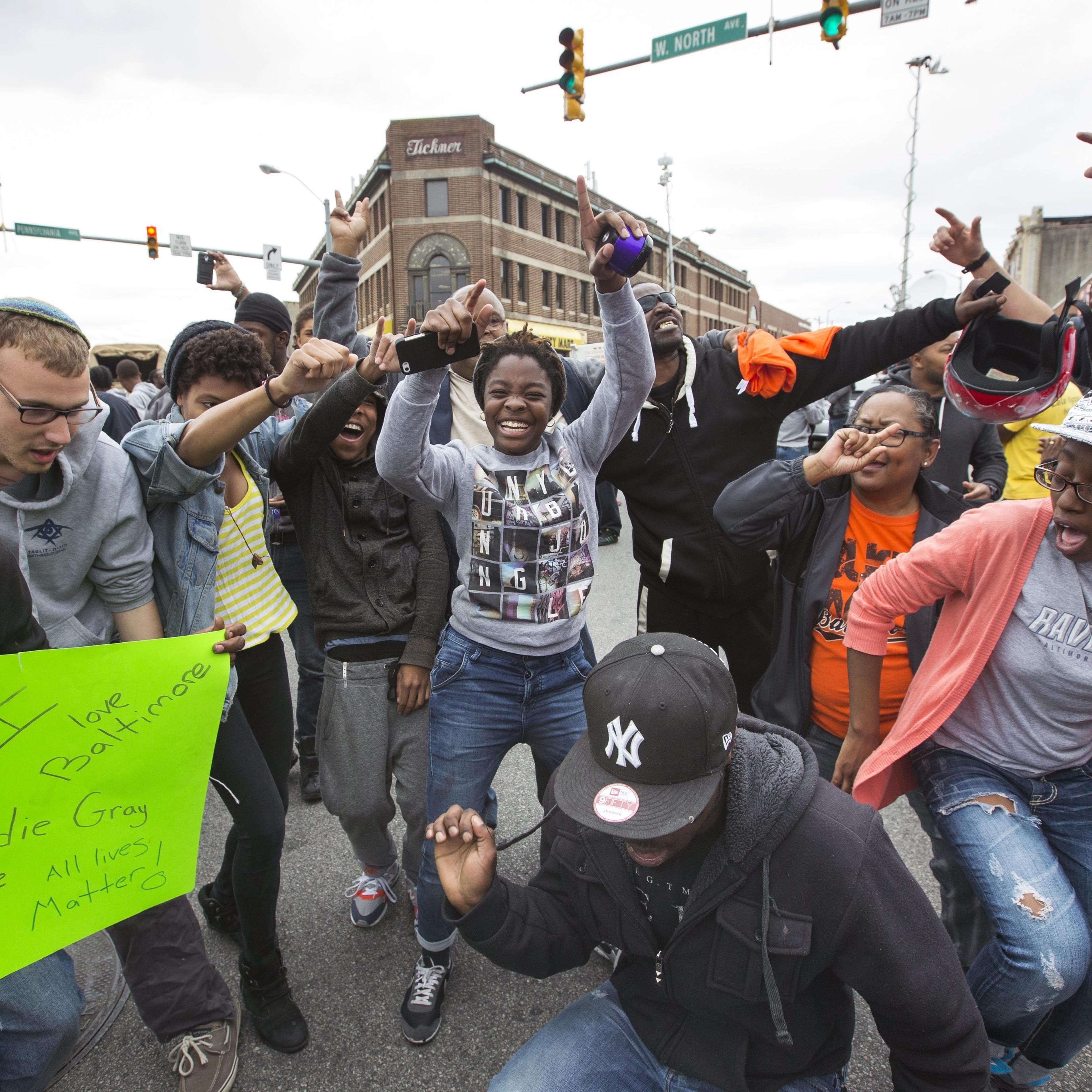 People celebrate in the streets of the Sandtown neighborhood in Baltimore after State Attorney Marilyn Mosby announced that six police officers are being charged in the death of Freddie Gray, in Baltimore on May 1, 2015.