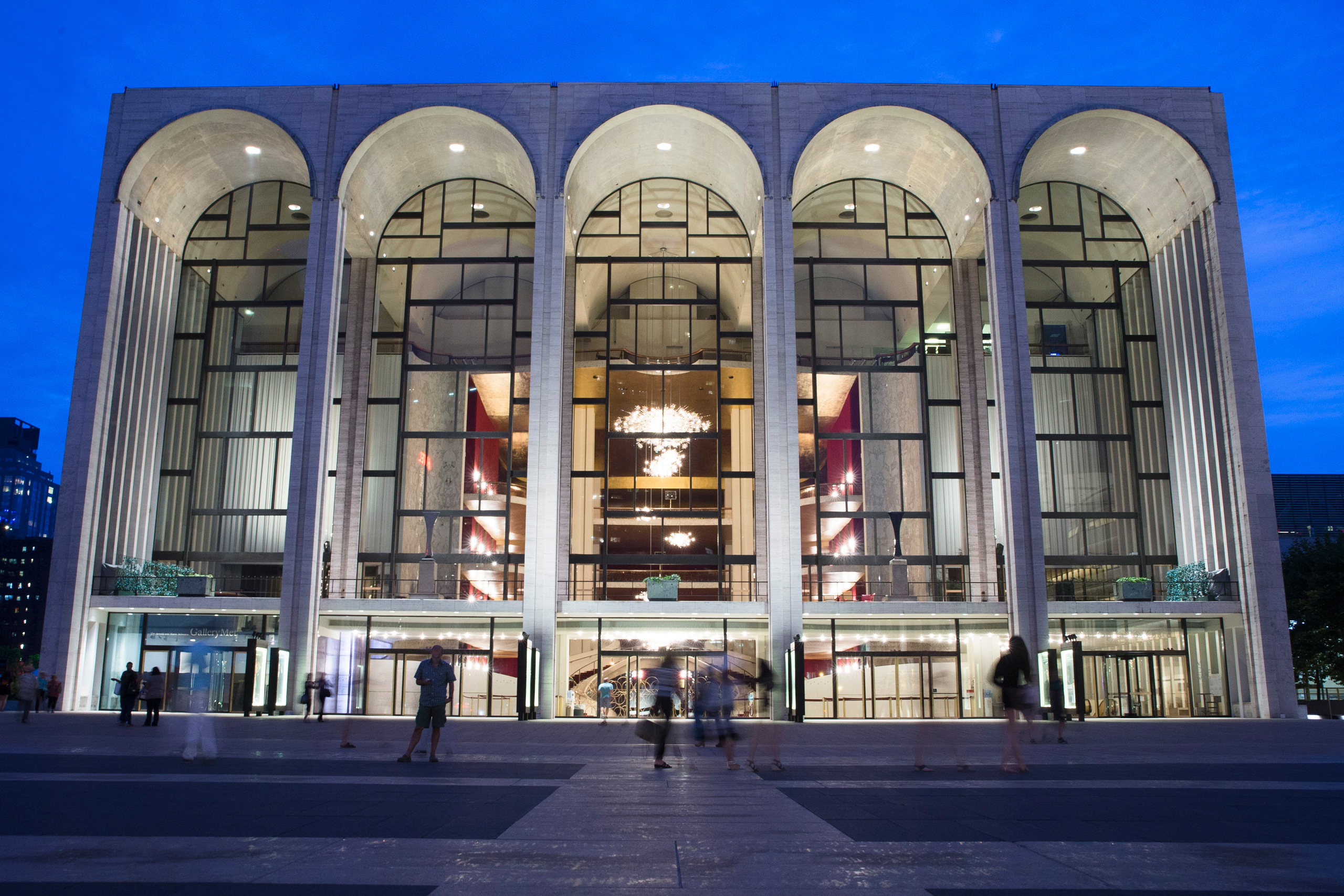 FILE - In this Aug. 1, 2014, file photo, pedestrians make their way in front of the Metropolitan Opera house at New York's Lincoln Center. New York's Metropolitan Opera stopped a performance Saturday, Oct. 29, 2016, after someone sprinkled an unknown pow