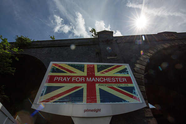 An ad screen displays 'Pray For Manchester' after the May 23, 2017 terrorist attack at an Ariana Grande concert in Manchester, England.