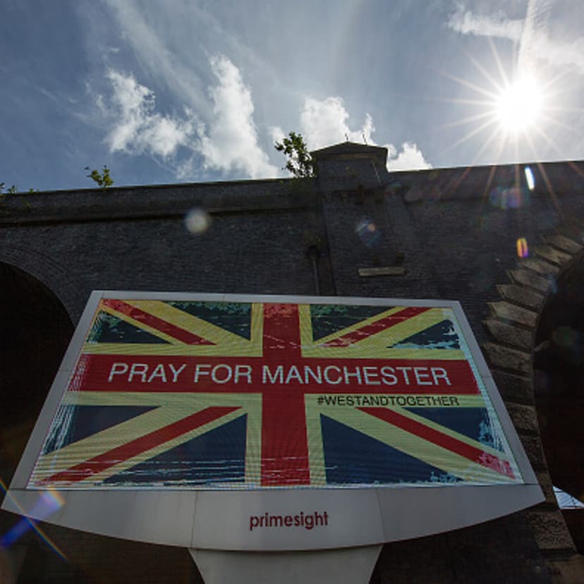 An ad screen displays 'Pray For Manchester' after the May 23, 2017 terrorist attack at an Ariana Grande concert in Manchester, England.
