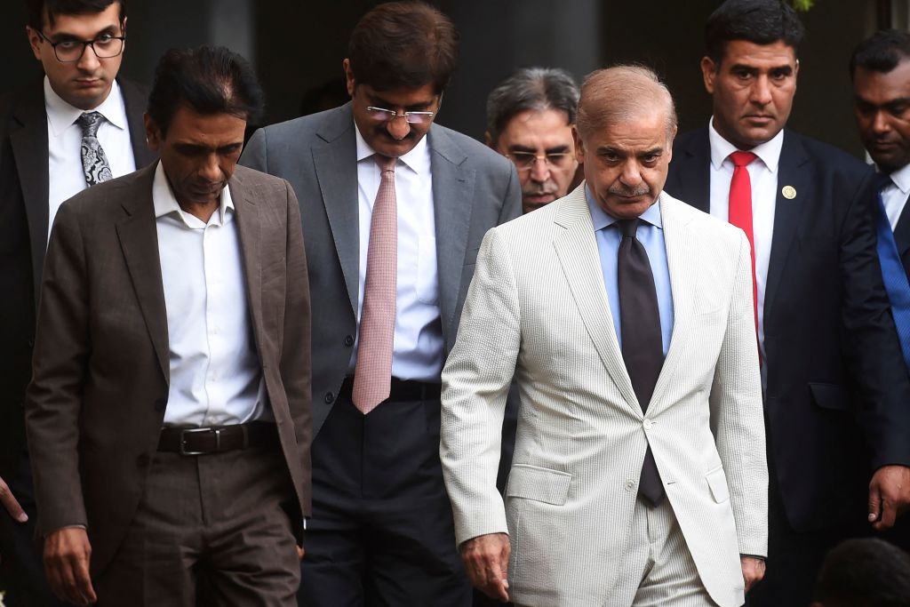 Pakistan's Prime Minister Shehbaz Sharif and leader of the Muttahida Qaumi Movement and collation partners of the newly formed government Khalid Maqbool Siddiqui leave after a meeting in Karachi on April 13, 2022.