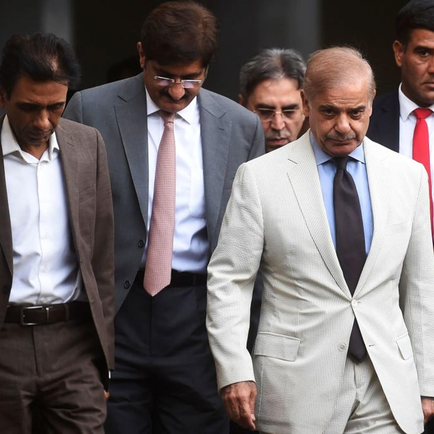 Pakistan's Prime Minister Shehbaz Sharif and leader of the Muttahida Qaumi Movement and collation partners of the newly formed government Khalid Maqbool Siddiqui leave after a meeting in Karachi on April 13, 2022.