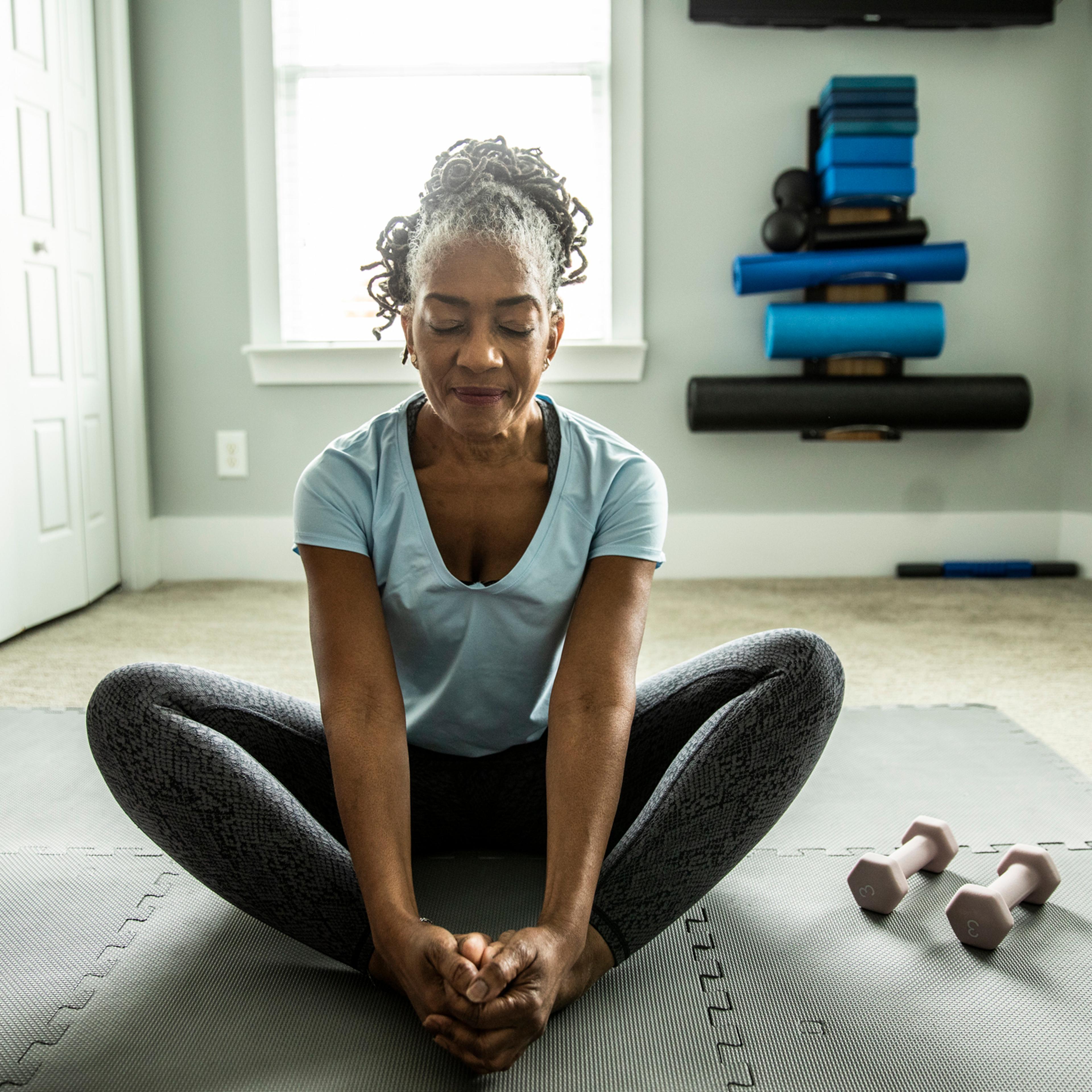 Senior woman exercising in home gym