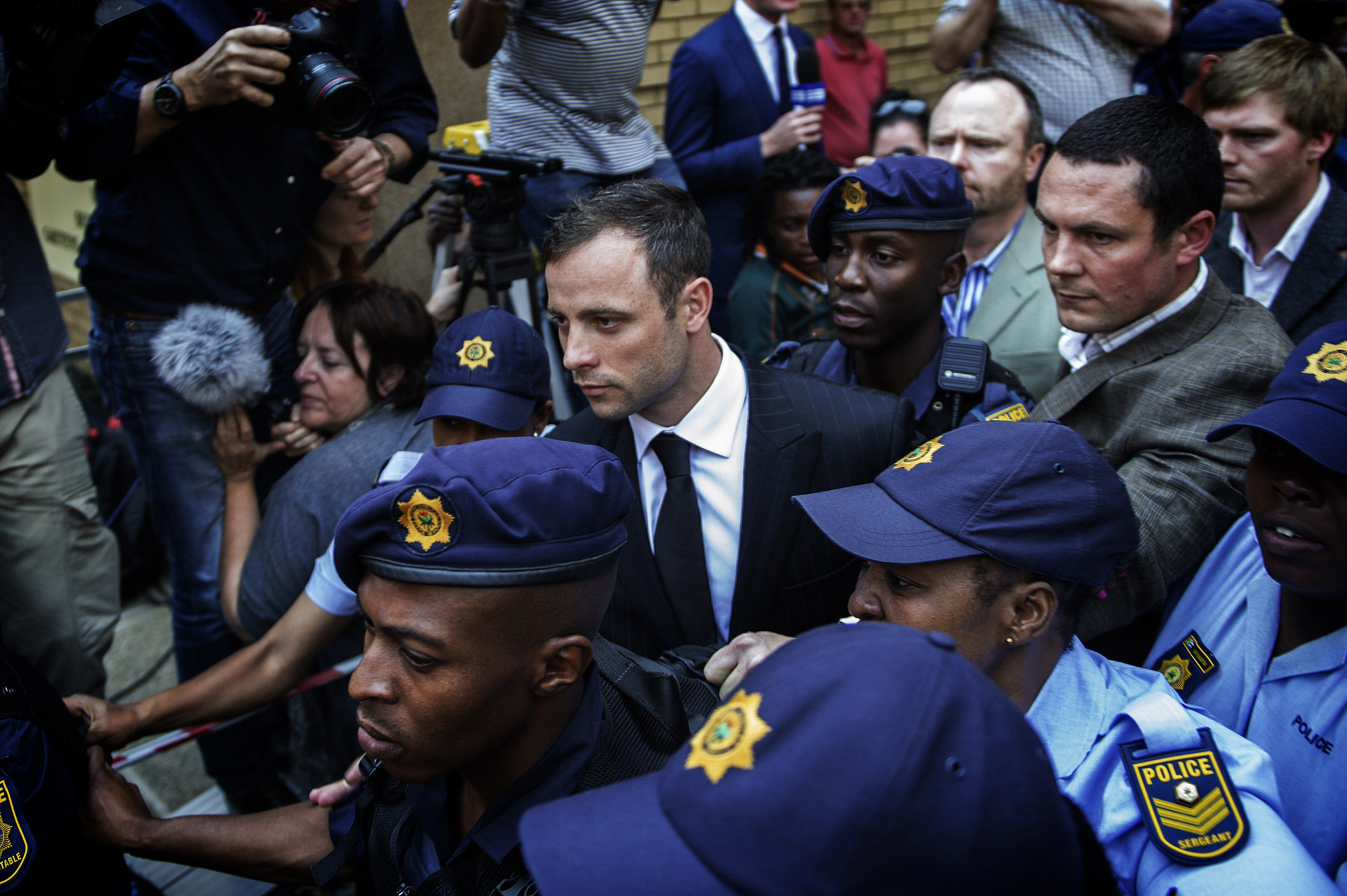 South African Paralympian athlete Oscar Pistorius leaves the High Court in Pretoria on Sept. 12, 2014.