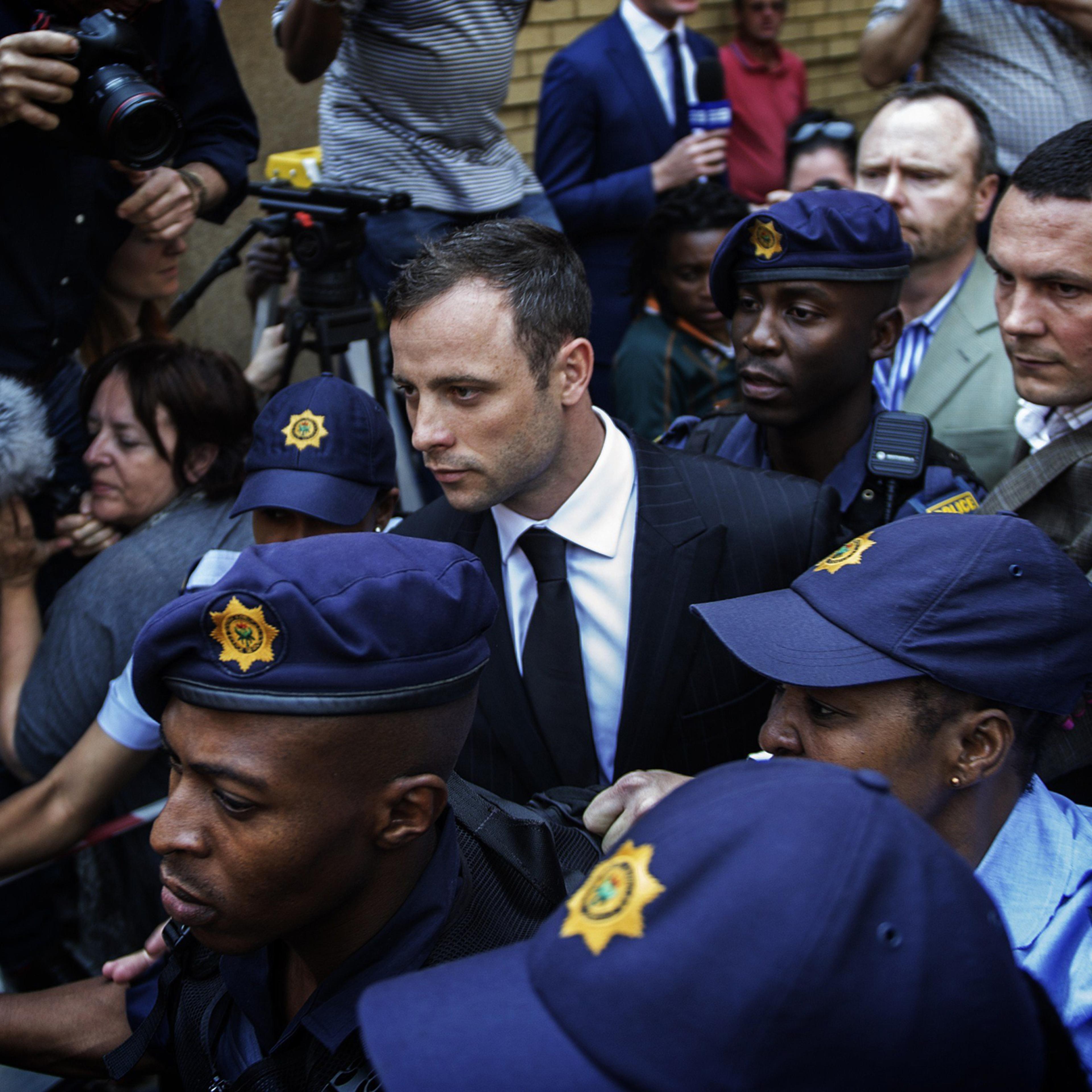 South African Paralympian athlete Oscar Pistorius leaves the High Court in Pretoria on Sept. 12, 2014.