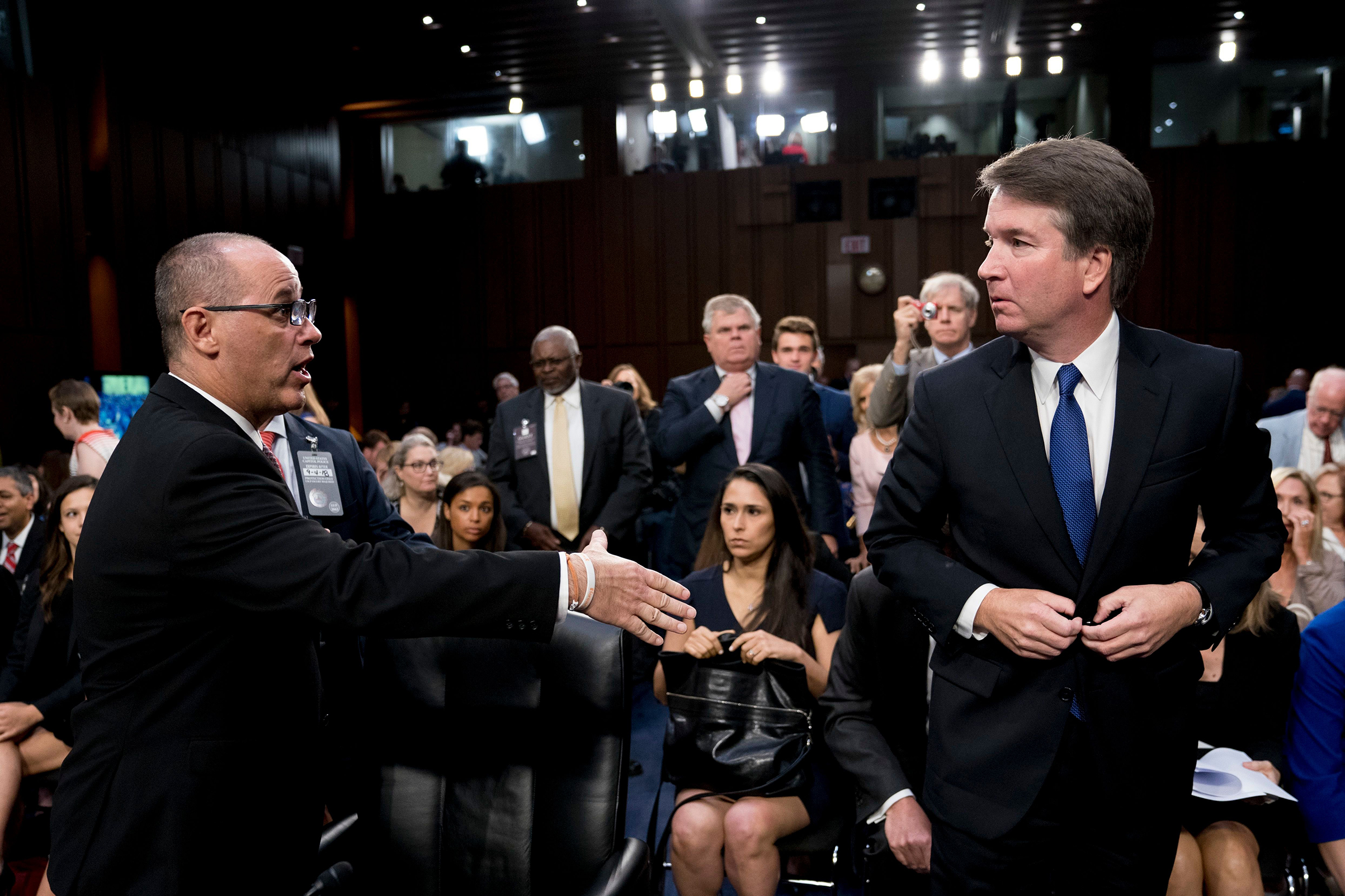 Fred Guttenberg, the father of Jamie Guttenberg who was killed in the Marjory Stoneman Douglas High School shooting in Parkland, Fla., left, attempts to shake hands with President Donald Trump's Supreme Court nominee, Brett Kavanaugh, right, as he leaves