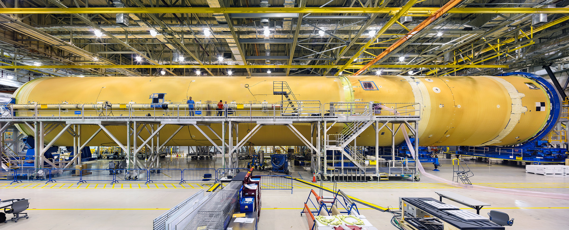 NASA workers assembling the core stage of the Space Launch System, the backbone of the moon rocket