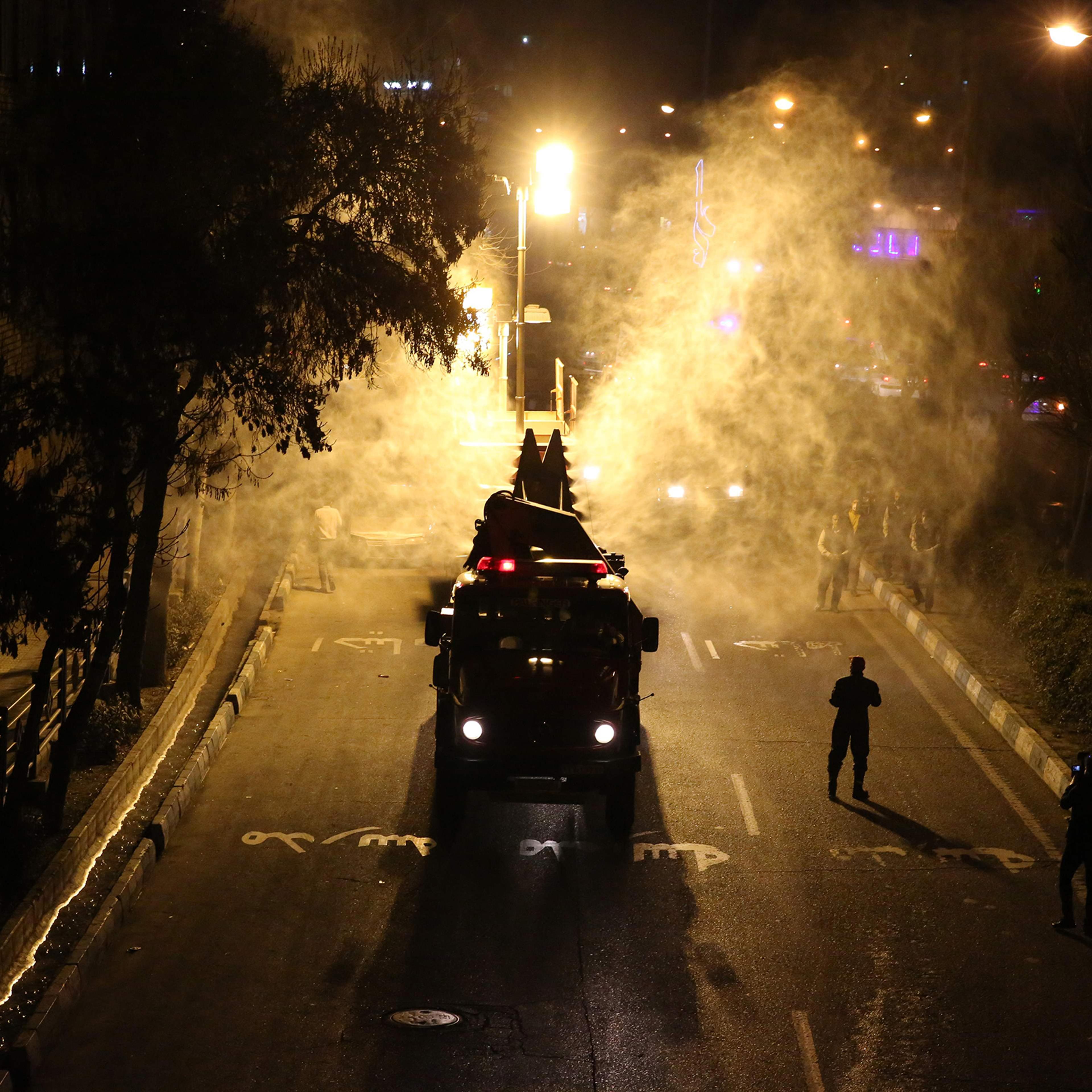 Iranian firefighters disinfect streets and allies in southern Tehran to halt the wild spread of coronavirus on March 11