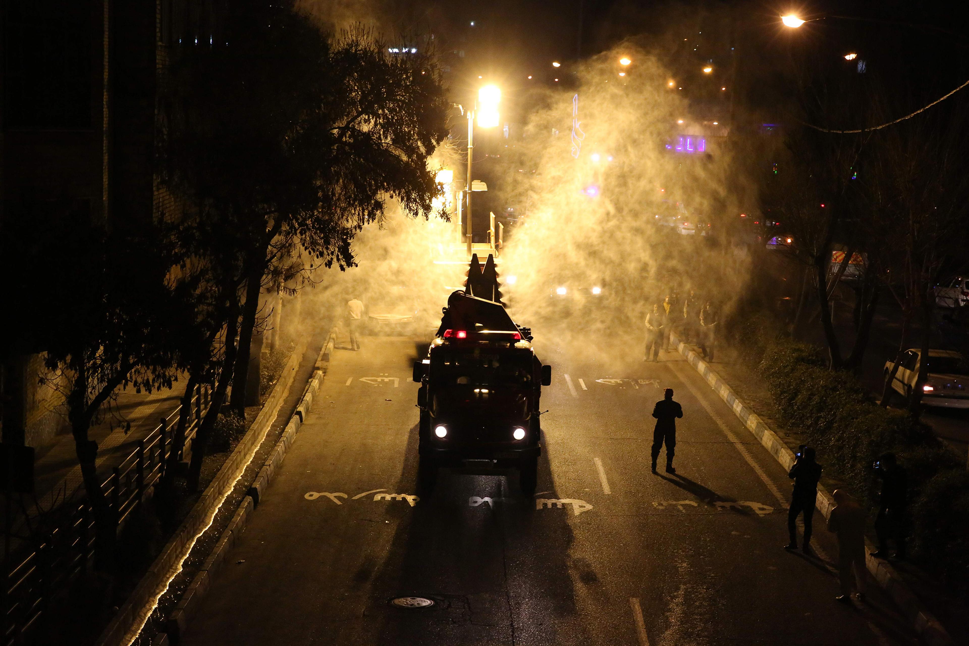 Iranian firefighters disinfect streets and allies in southern Tehran to halt the wild spread of coronavirus on March 11