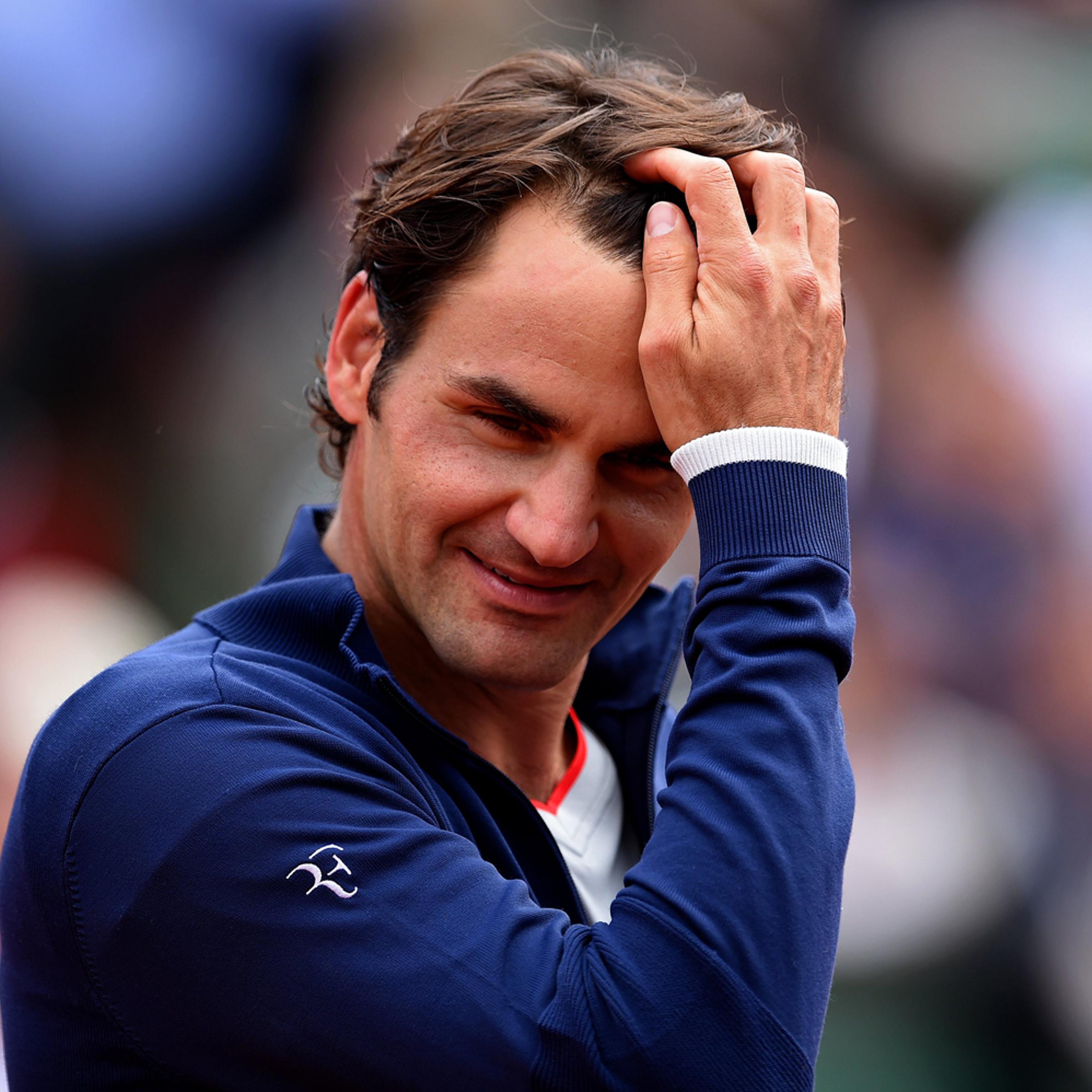 Roger Federer smiles following victory in his men's singles match against Lukas Lacko of Slovakia on day one of the French Open at Roland Garros on May 25, 2014 in Paris.