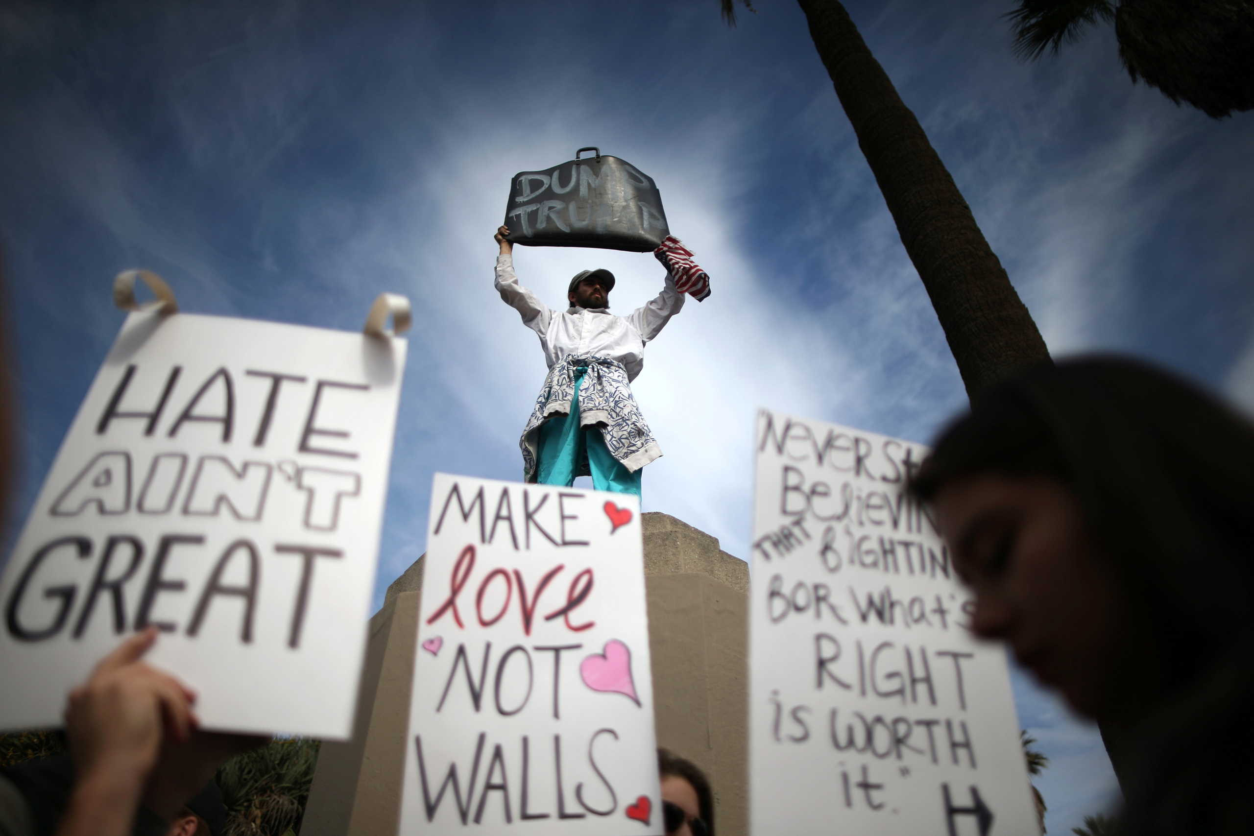 People hold signs during a march and rally against the election of Republican Donald Trump as President of the United States in Los Angeles, California, U.S. November 12, 2016. REUTERS/Lucy Nicholson TPX IMAGES OF THE DAY - RTX2TDMB