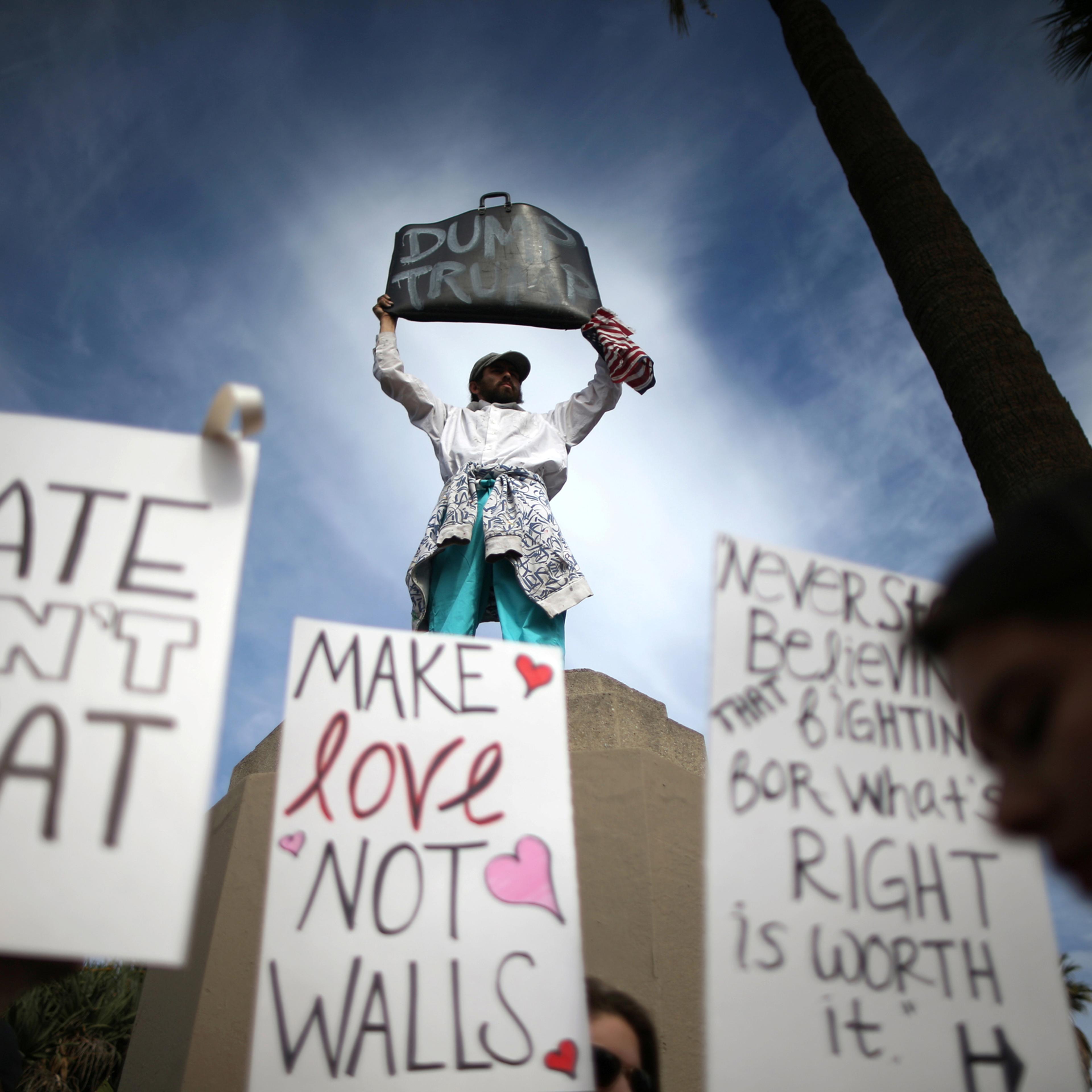 People hold signs during a march and rally against the election of Republican Donald Trump as President of the United States in Los Angeles, California, U.S. November 12, 2016. REUTERS/Lucy Nicholson TPX IMAGES OF THE DAY - RTX2TDMB