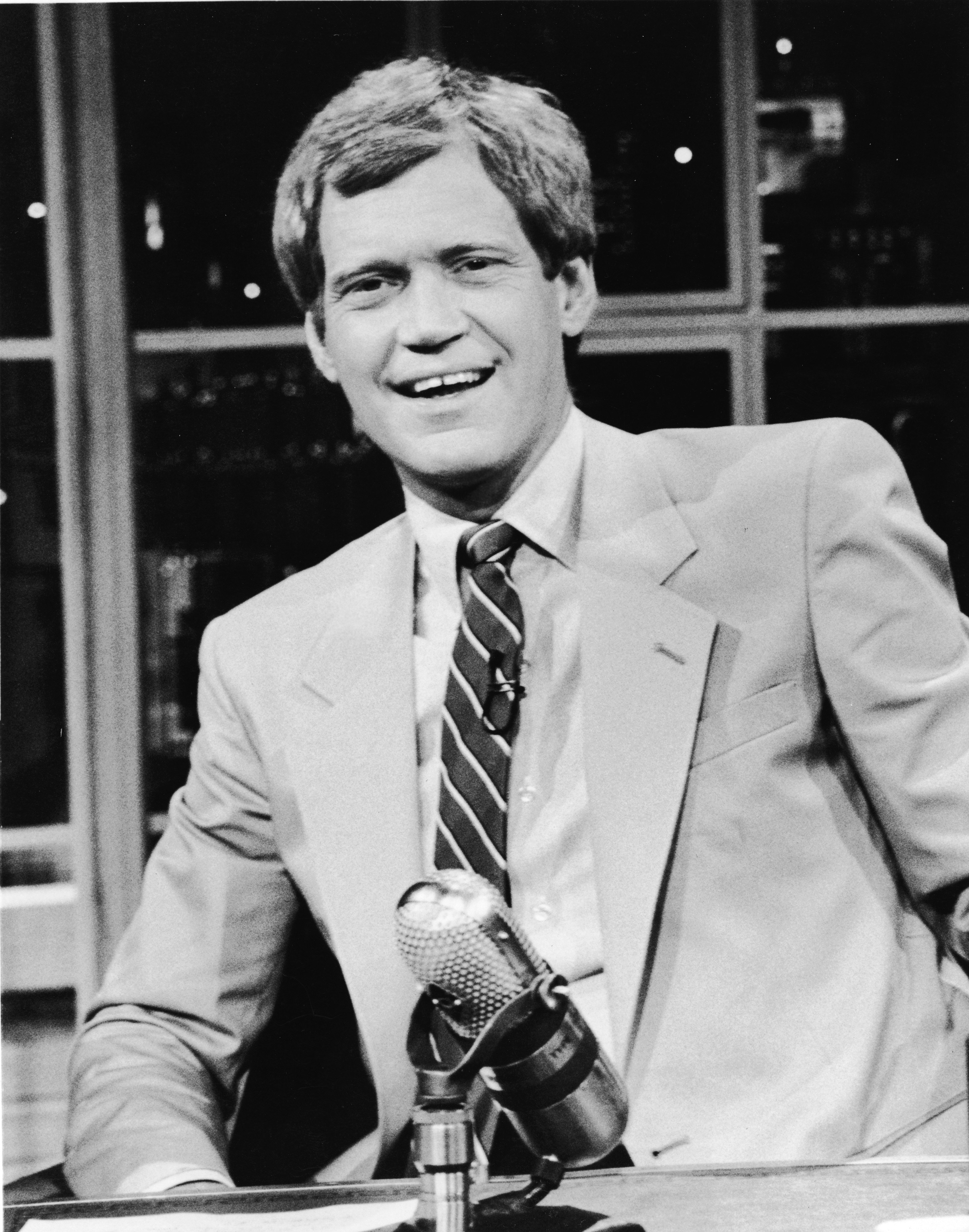 David Letterman sits at his desk on 'Late Night with David Letterman,' in New York, 1986.