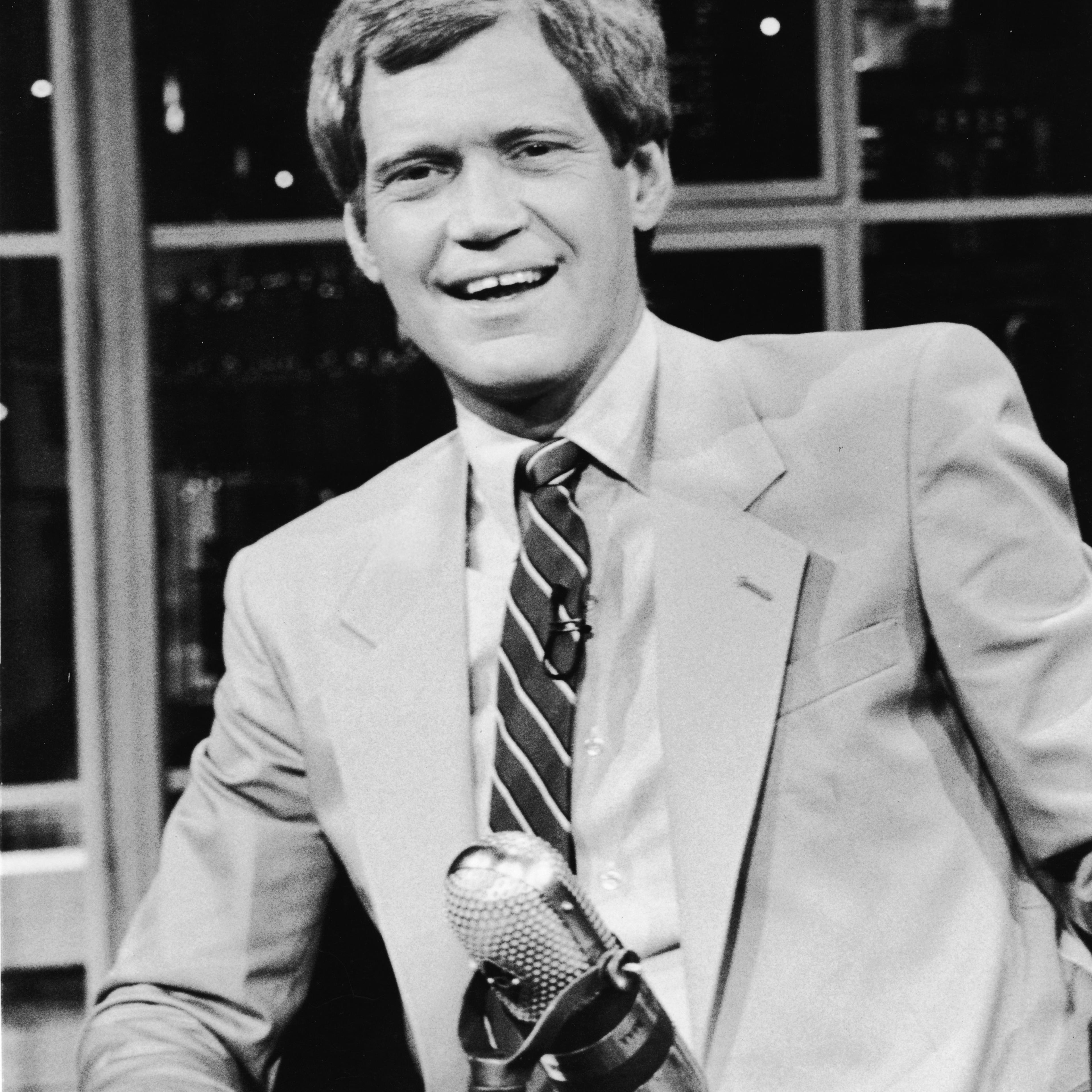 David Letterman sits at his desk on 'Late Night with David Letterman,' in New York, 1986.