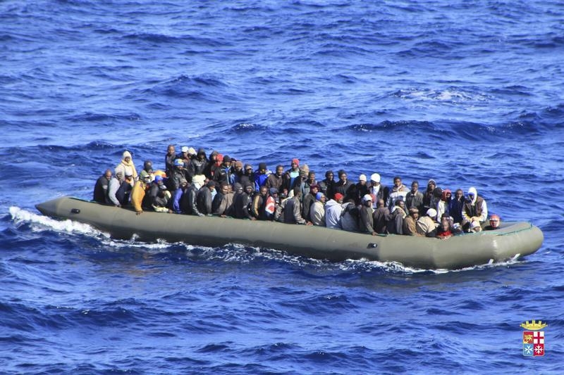 Migrants are seen in a boat during a rescue operation by Italian navy ship San Marco off the coast to the south of the Italian island of Sicily