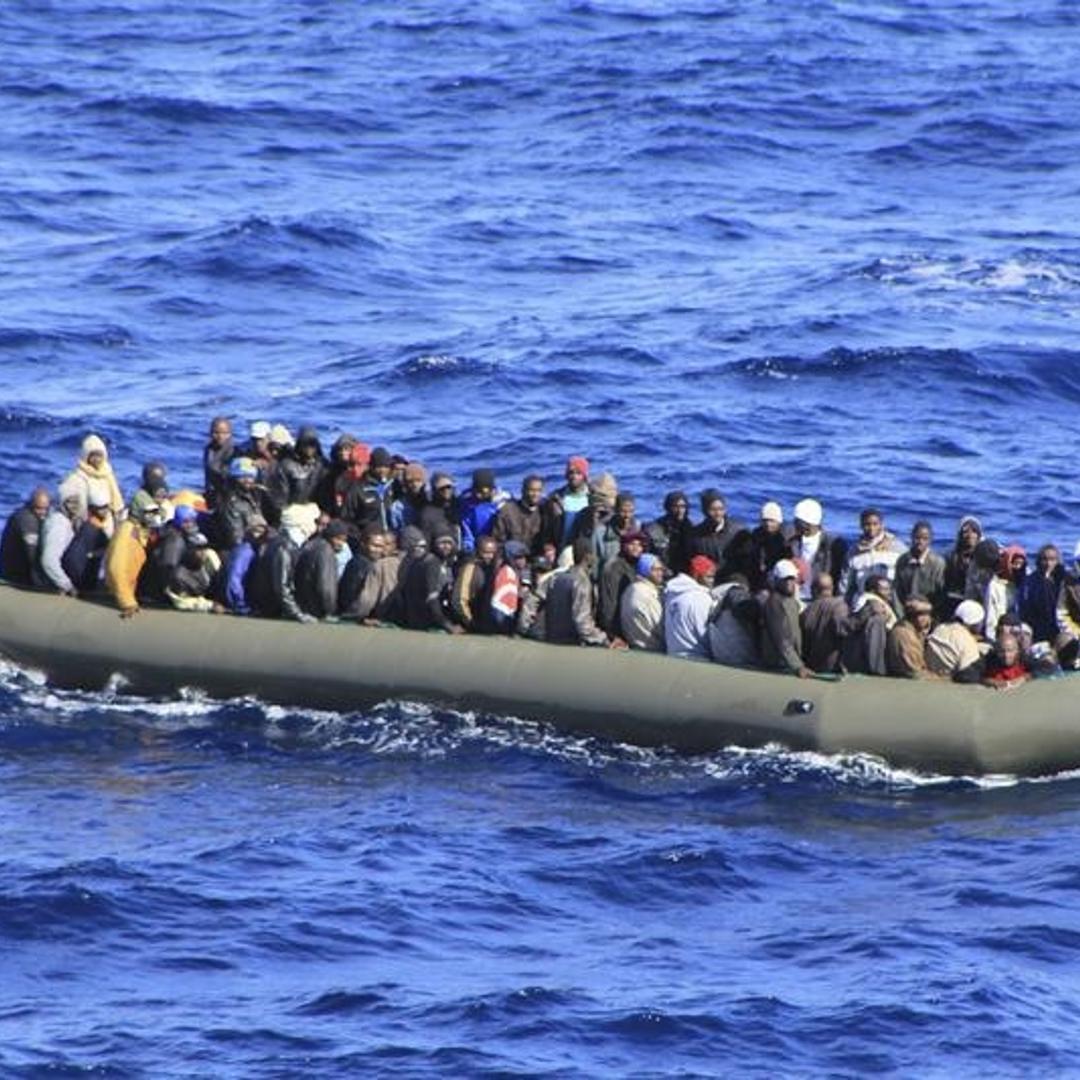 Migrants are seen in a boat during a rescue operation by Italian navy ship San Marco off the coast to the south of the Italian island of Sicily