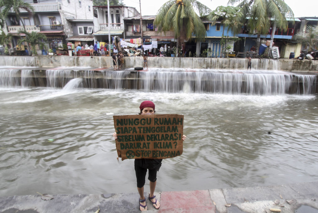 Environment activists hold action in coastal Jakarta to protest climate change