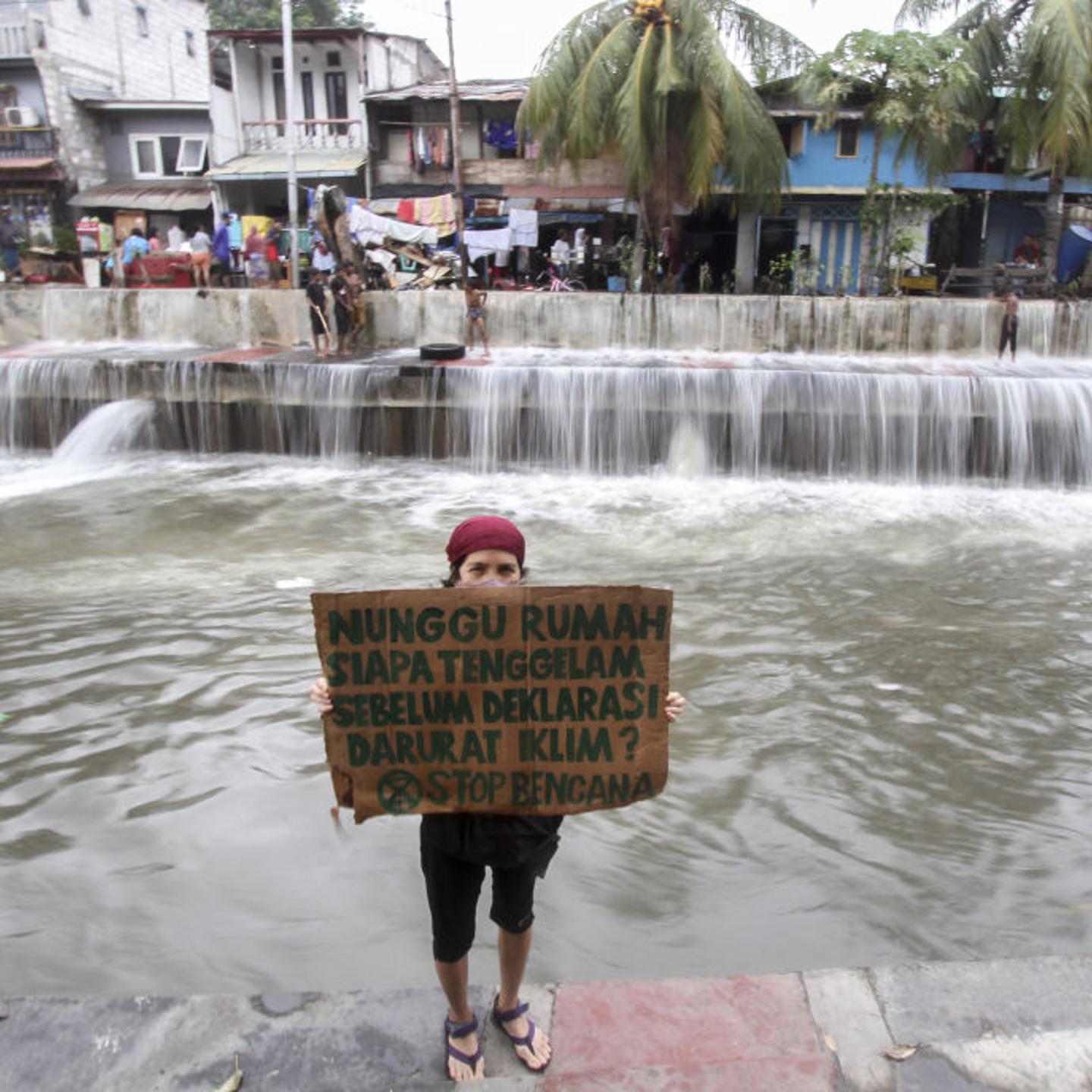 Environment activists hold action in coastal Jakarta to protest climate change