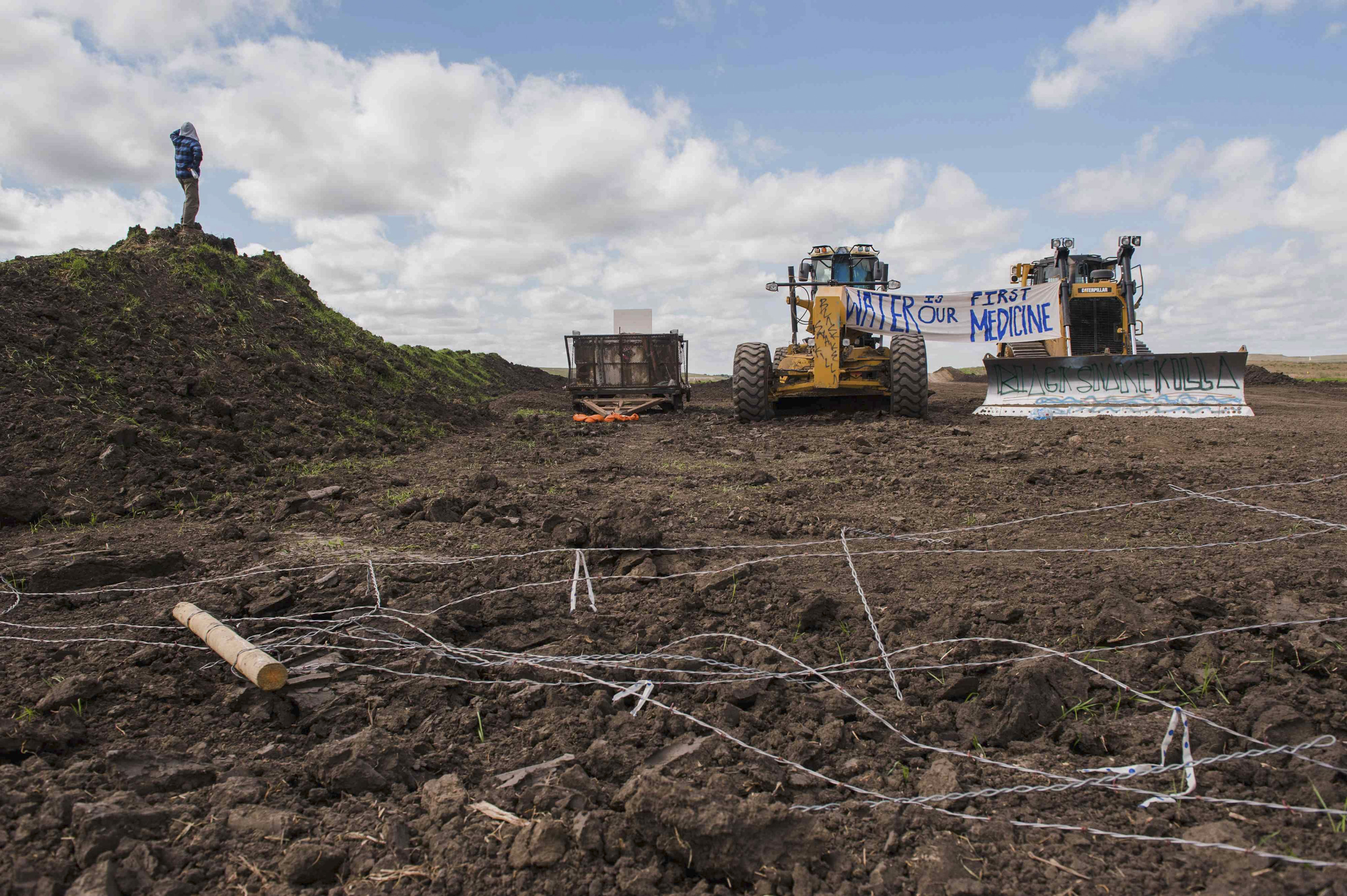 Signs hang from heavy machinery after protesters stopped construction on the Energy Transfer Partners Dakota Access oil pipeline near the Standing Rock Sioux reservation in Cannon Ball, North Dakota on Sept. 6, 2016.