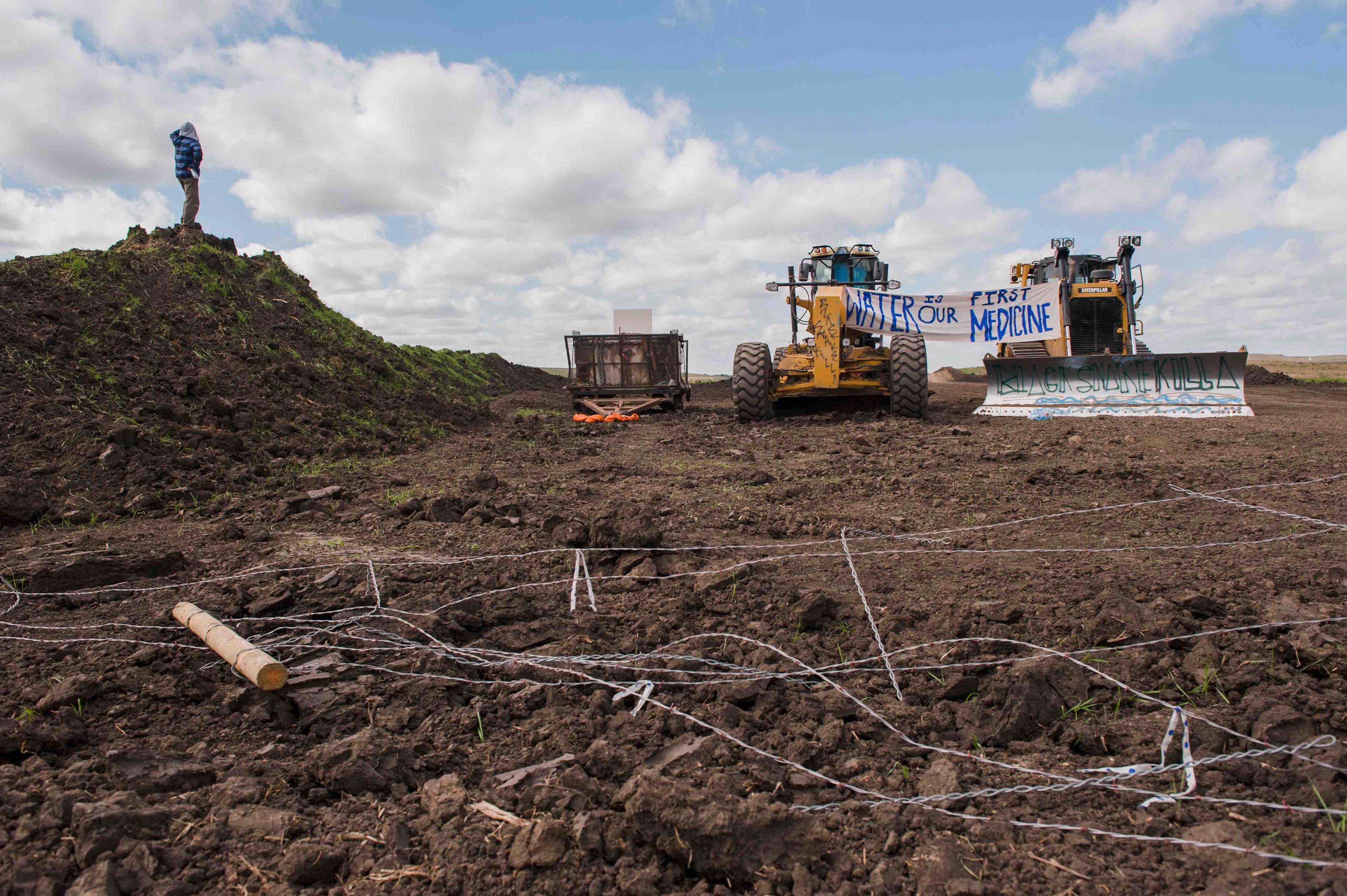 Signs hang from heavy machinery after protesters stopped construction on the Energy Transfer Partners Dakota Access oil pipeline near the Standing Rock Sioux reservation in Cannon Ball, North Dakota on Sept. 6, 2016.