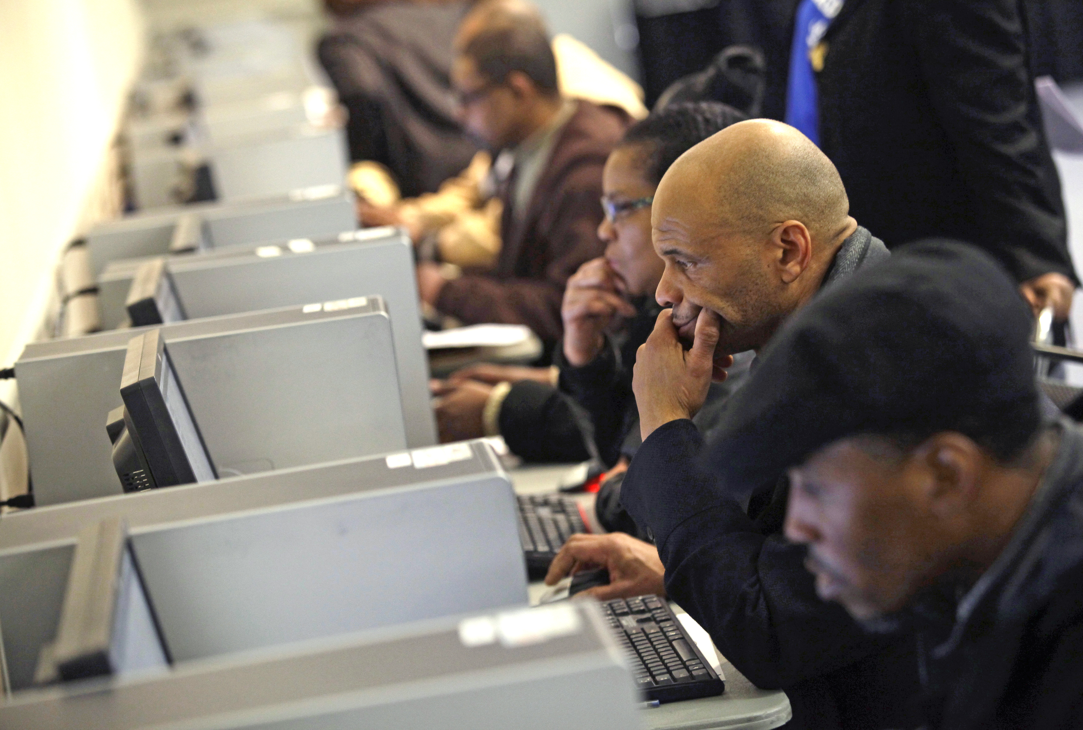 People use computers at a job fair in Detroit on March 1, 2014.