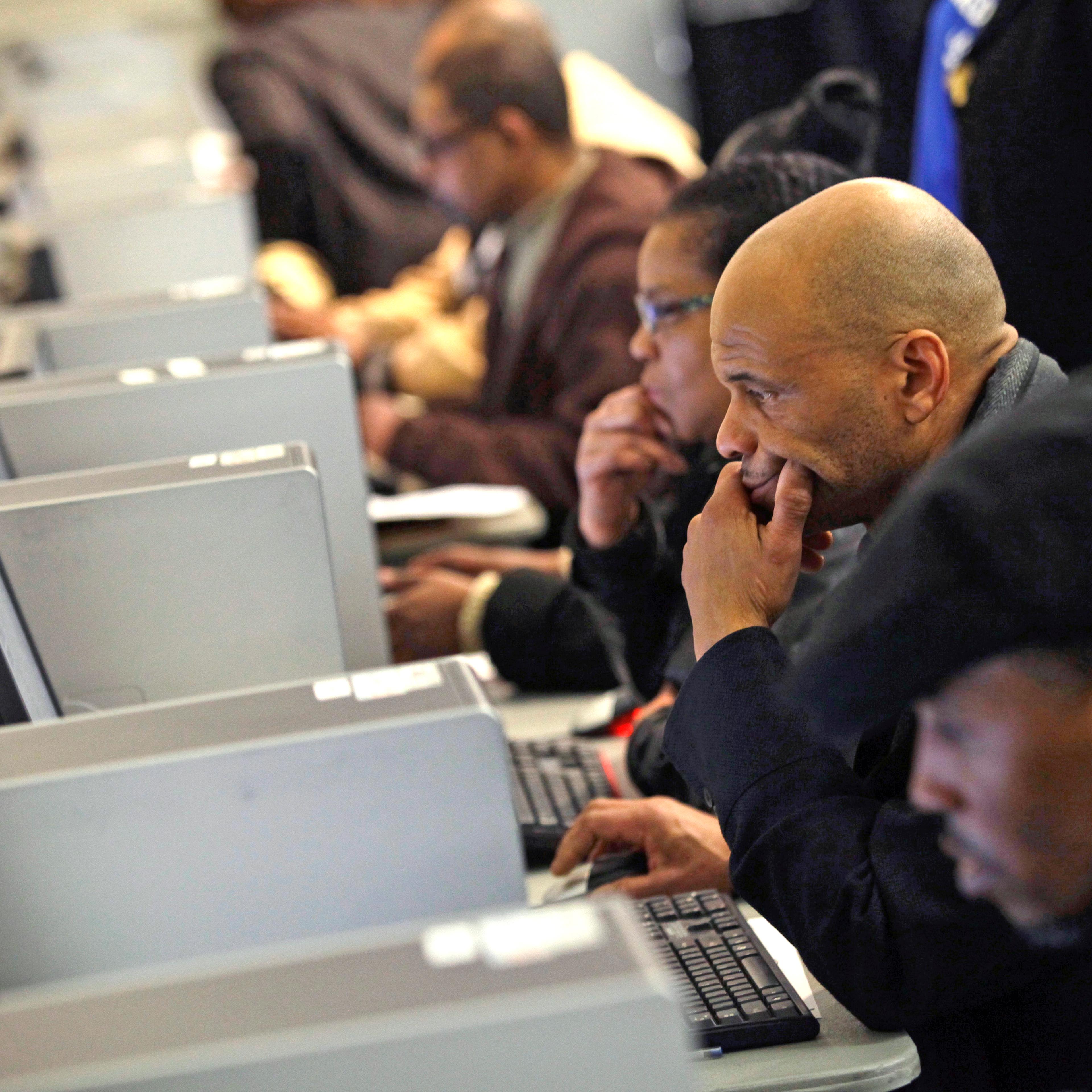 People use computers at a job fair in Detroit on March 1, 2014.