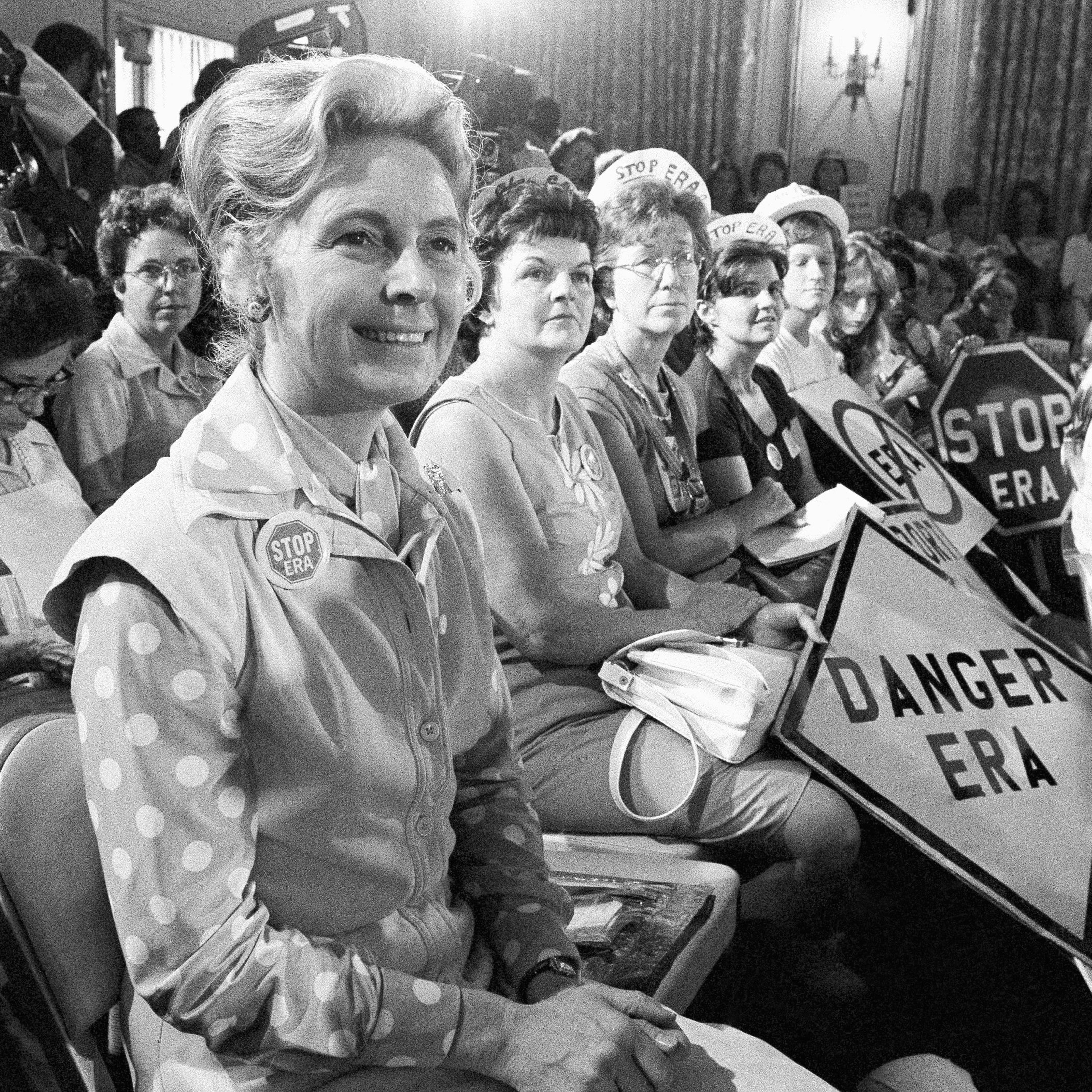 Phyllis Schlafly, left, sit with women opposed to the Equal Rights Amendment during a Republican platform subcommittee hearing in Kansas City, Mo, Aug. 10, 1976.