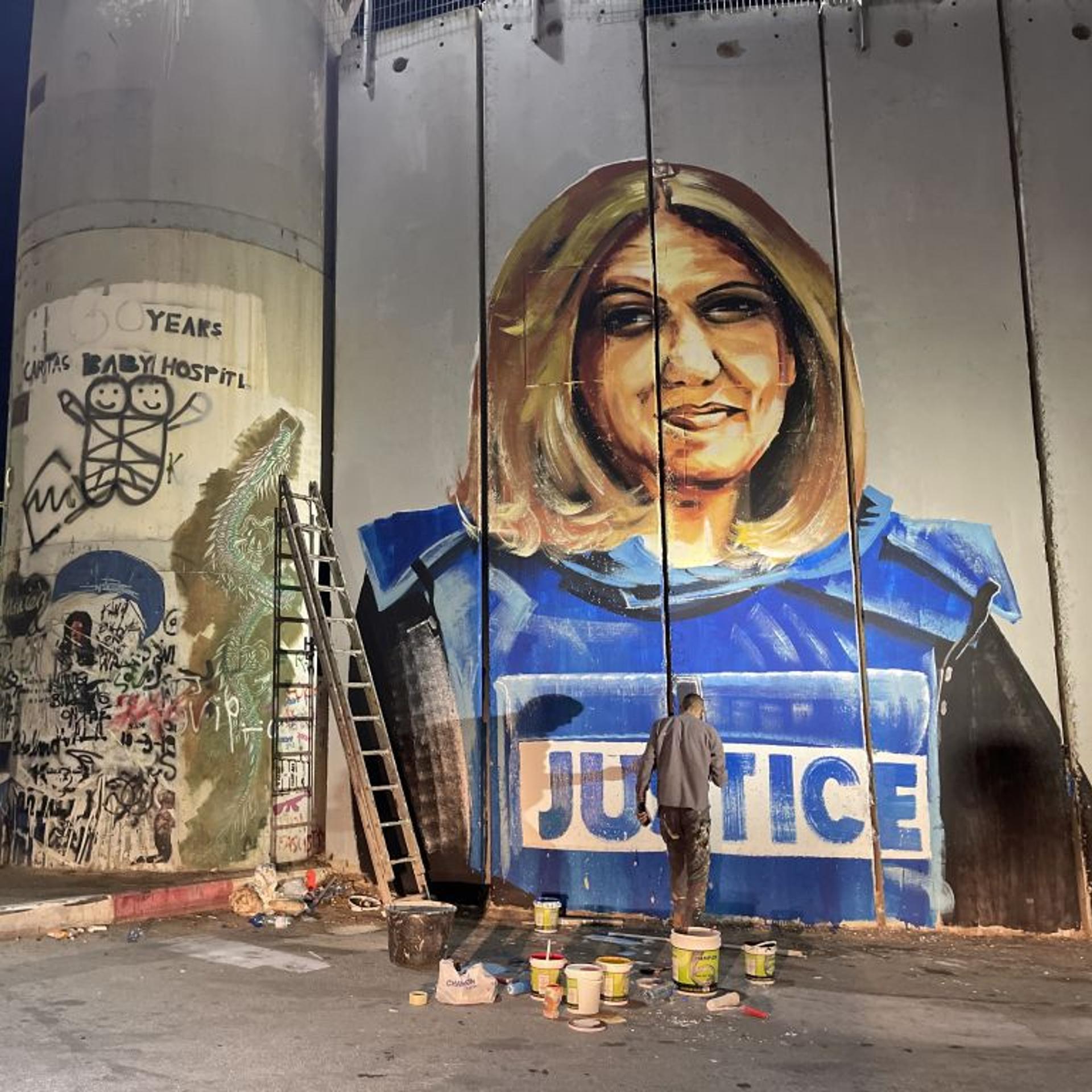 Palestinian artist's graffiti on Israel's separation wall attracts attention