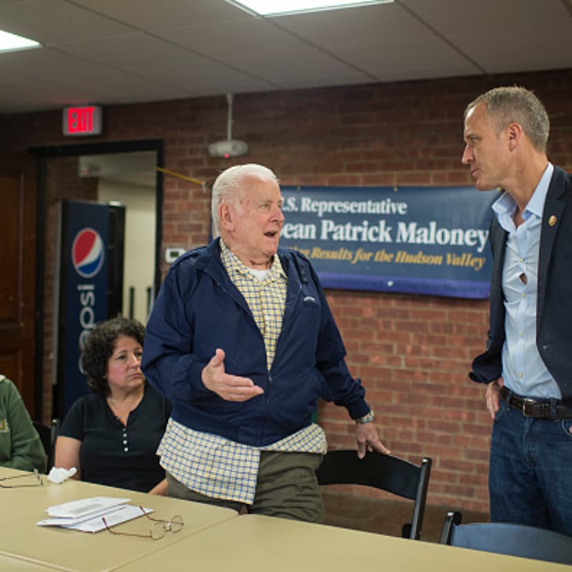 Rep. Sean Patrick Maloney, D-N.Y., talks with constituents Theresa Yantz, 79, left, her husband Larry, 81, standing, and their daughter Patricia Wenzel, 55, during a town hall in Newburgh, N.Y., June 11, 2016.